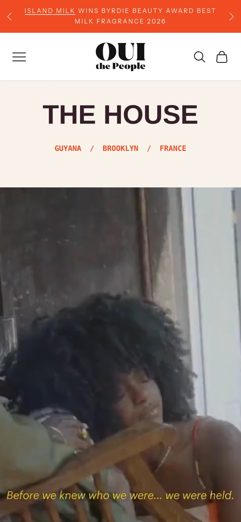 The mobile version simplifies the layout with a hamburger menu, central logo, search, and shopping bag icons in the header. The 'THE HOUSE' headline and location links are centered above a large, full-width hero image that includes the text 'Before we knew who we were... we were held.' at the bottom.