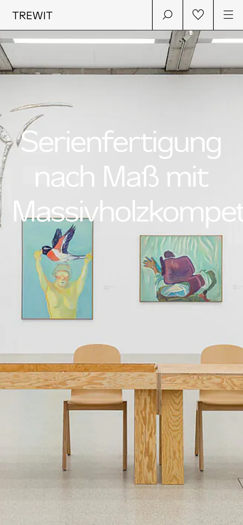The mobile version presents a vertically stacked layout starting with a large hero image of a gallery setting with wooden furniture and art. The headline is prominently centered in large white text. The navigation is condensed into a hamburger menu icon on the right, with search and heart icons positioned in a top bar next to the TREWIT logo.