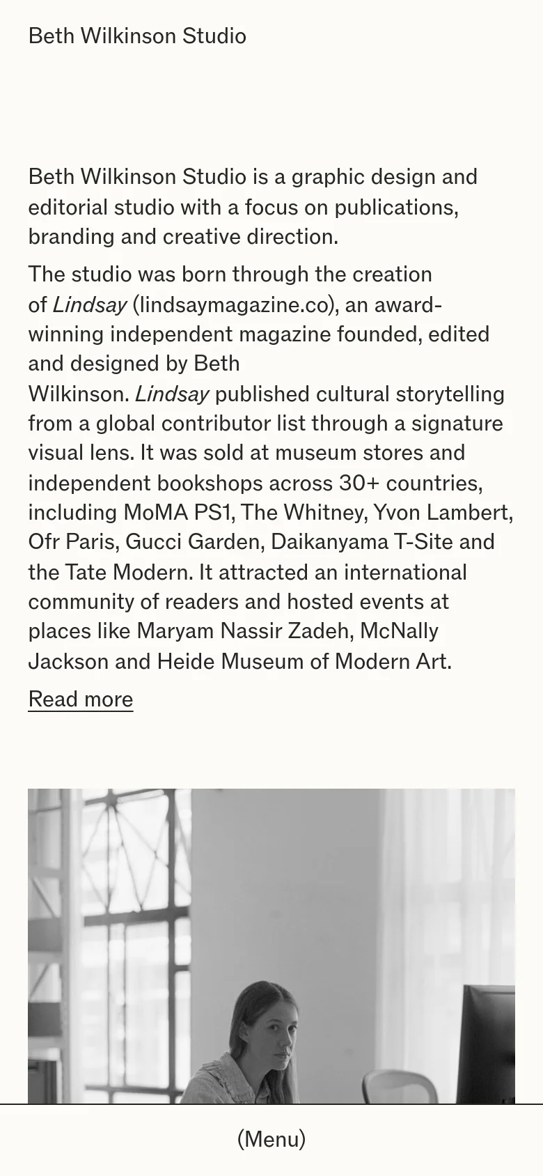 The mobile version presents a simplified, single-column layout optimized for vertical scrolling. The studio name is prominent at the top, followed by the descriptive text, and a 'Menu' button is centered at the bottom of the screen. The multi-column desktop layout is replaced by a stacked arrangement of text and imagery.