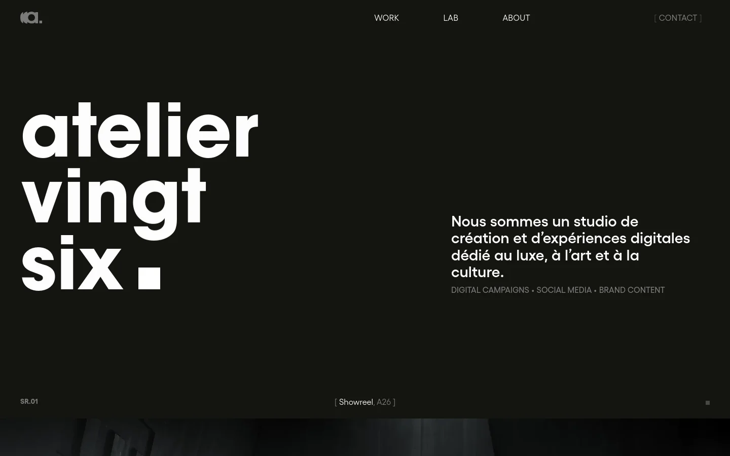 The desktop homepage features a minimalist dark theme with large white typography reading 'atelier vingt six'. A navigation menu at the top includes links for Work, Lab, About, and Contact, while a descriptive text block on the right explains the studio's focus on luxury, art, and culture. Below the hero section, a grid of high-quality project thumbnails showcases various brand works.