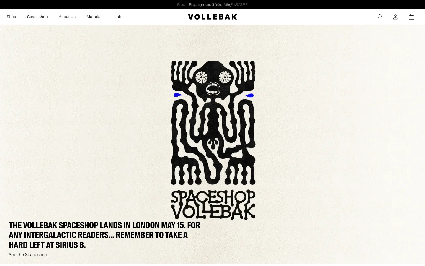 The Vollebak homepage features a minimalist, high-contrast design with a cream background and black typography. A large, central graphic depicts a stylized black skull-like figure with blue accents above the text announcing the London Spaceshop landing on May 15. The navigation bar at the top includes links for Shop, Spaceshop, About Us, and Lab, alongside search, user, and cart icons.