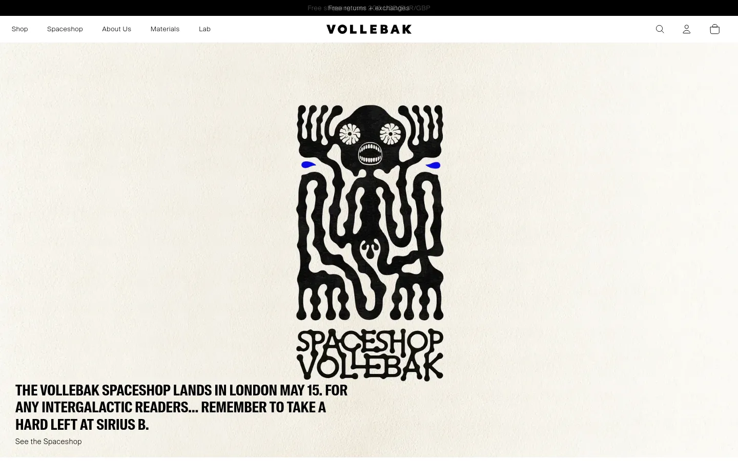 The Vollebak homepage features a minimalist, high-contrast design with a cream background and black typography. A large, central graphic depicts a stylized black skull-like figure with blue accents above the text announcing the London Spaceshop landing on May 15. The navigation bar at the top includes links for Shop, Spaceshop, About Us, and Lab, alongside search, user, and cart icons.