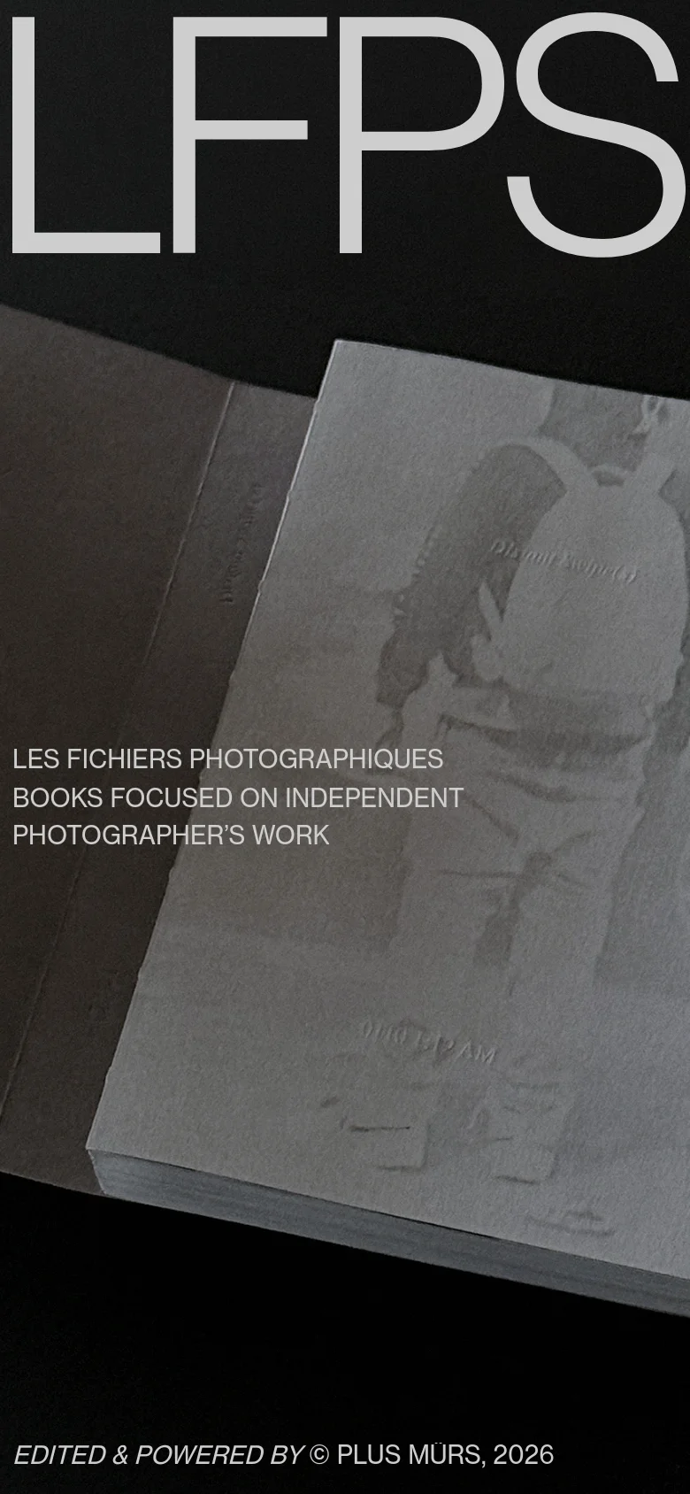 The mobile version maintains the minimalist aesthetic with the large 'LFPS' header dominating the top of the screen over a close-up of the photography book. The layout is vertically stacked, with the site description and 'EDITED & POWERED BY' credits positioned below the central imagery.