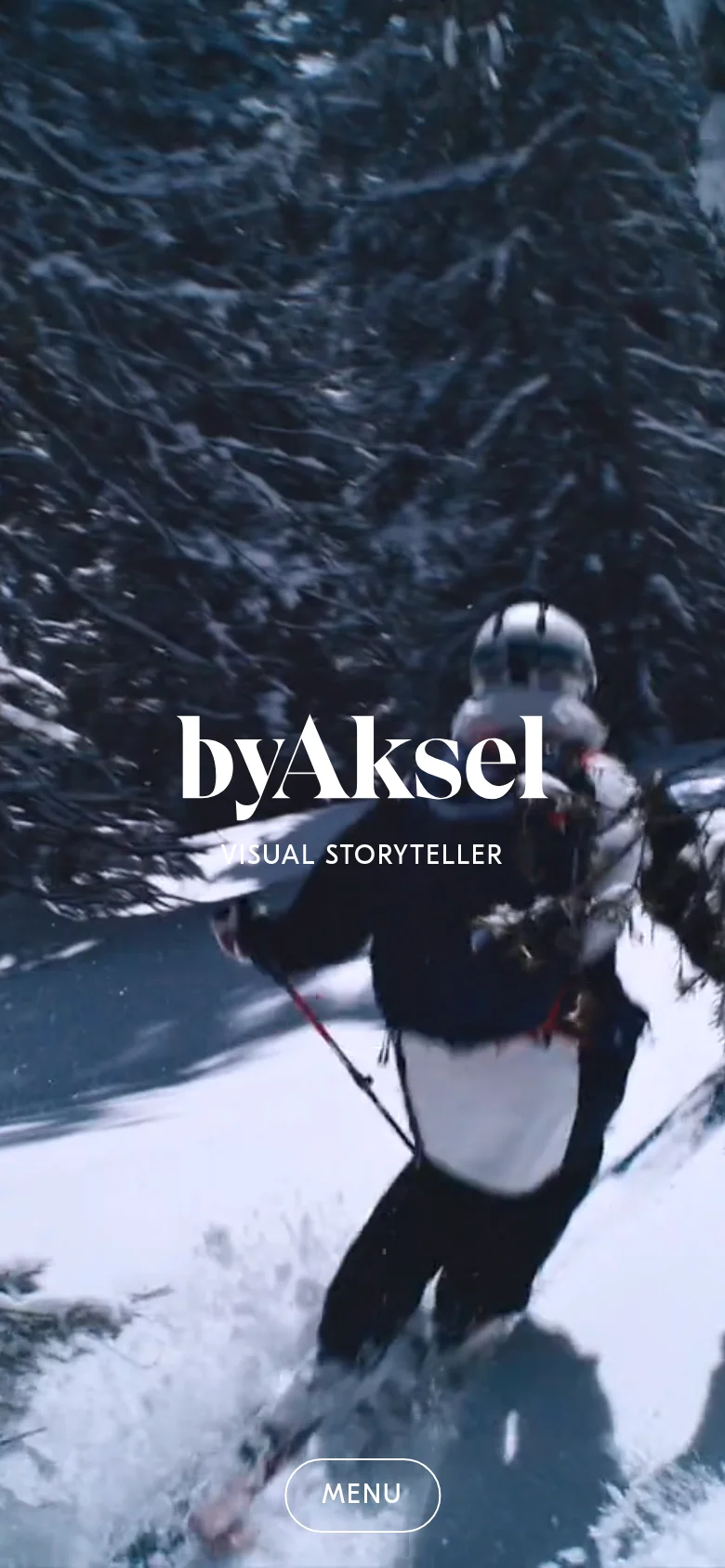 The mobile version maintains the immersive full-screen snowy forest imagery and centered white typography. The primary difference is the addition of a prominent 'MENU' button at the bottom of the screen to facilitate navigation on a smaller device.