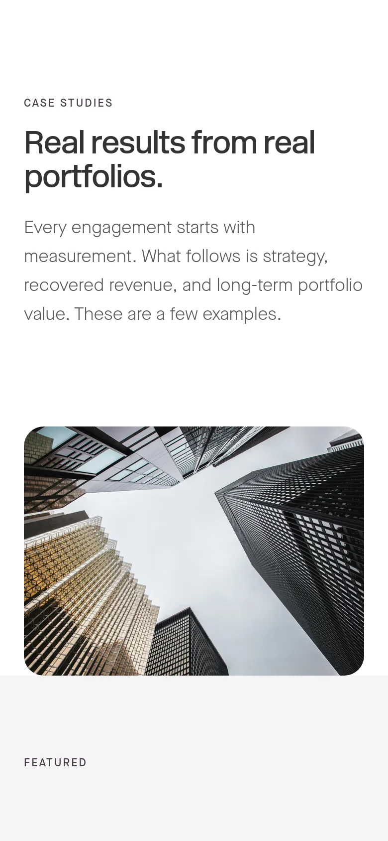 The mobile version maintains the same content and minimalist white background but uses a narrower, vertically oriented layout. The hero image of skyscrapers is scaled down to fit the screen width, and the text is stacked vertically to ensure readability on a smaller display.