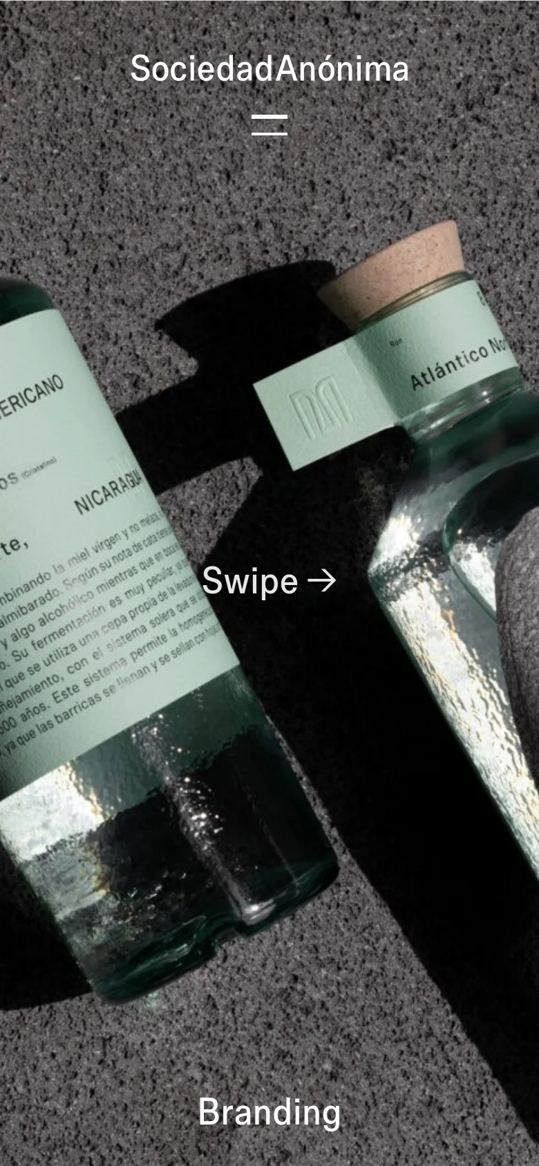 The mobile version displays a vertically oriented close-up of the Ron Mesoamericano bottles with a dark, textured background. The layout is simplified, featuring the brand name 'Sociedad Anónima' and a menu icon at the top, a 'Swipe' call to action in the center, and the word 'Branding' at the bottom.