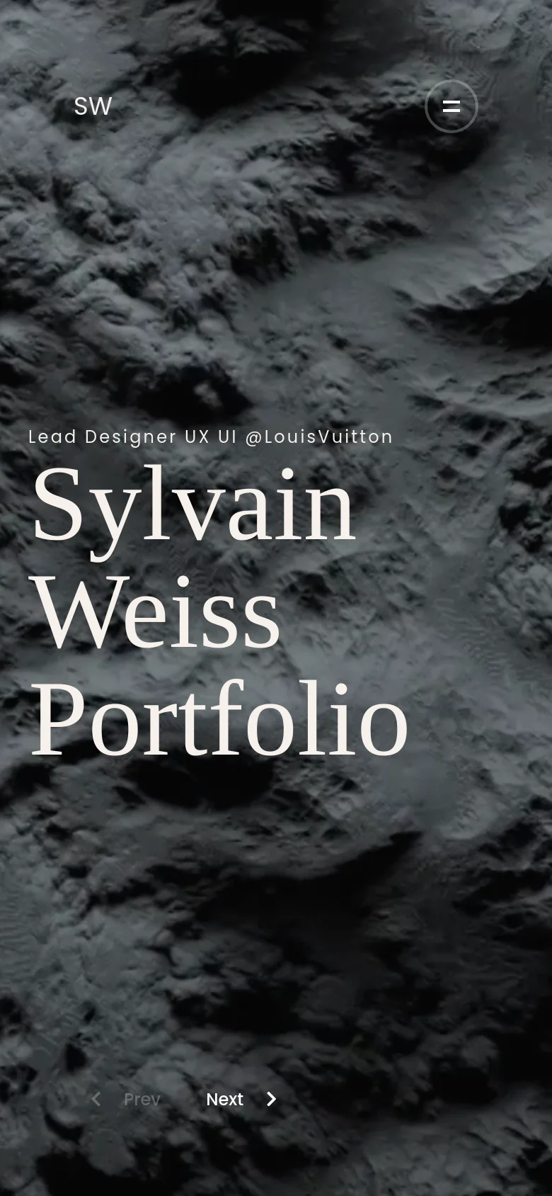 The mobile version maintains the dark, rocky textured background and white serif typography, but the layout is vertically oriented. The headline 'Sylvain Weiss Portfolio' is stacked and centered, while the 'Prev' and 'Next' navigation buttons are positioned at the bottom center of the screen.