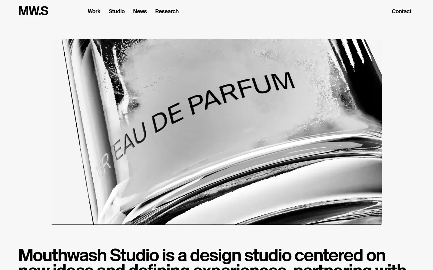 Mouthwash Studio homepage featuring a minimalist black and white design. A large, high-contrast hero image of a glass perfume bottle with Eau De Parfum text sits above bold, oversized sans-serif typography. The layout uses a clean, spacious aesthetic with a simple top navigation menu.