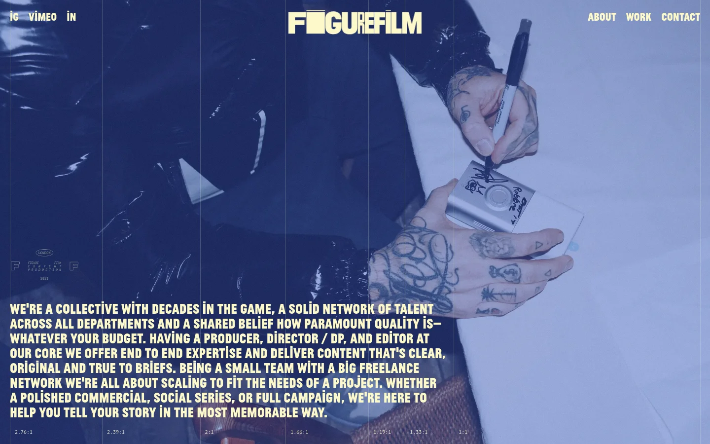 The desktop About page features a large, cinematic hero image of a person's tattooed hands writing, overlaid with white text describing the film collective. The navigation menu is at the top right, and the brand logo is centered at the top. The layout uses a dark, moody color palette with high-contrast white typography.