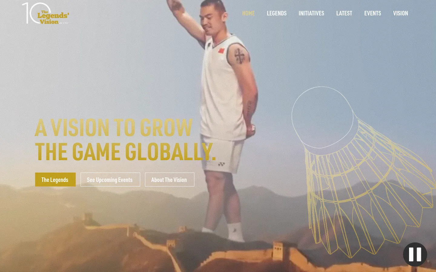 The desktop landing page features a large hero image of a badminton player against a scenic mountain backdrop with a large gold outline of a shuttlecock. The headline 'A VISION TO GROW THE GAME GLOBALLY' is displayed in bold gold text above three rectangular call-to-action buttons: 'The Legends', 'See Upcoming Events', and 'About The Vision'. A navigation menu is visible at the top right, and a pause button sits in the bottom right corner.