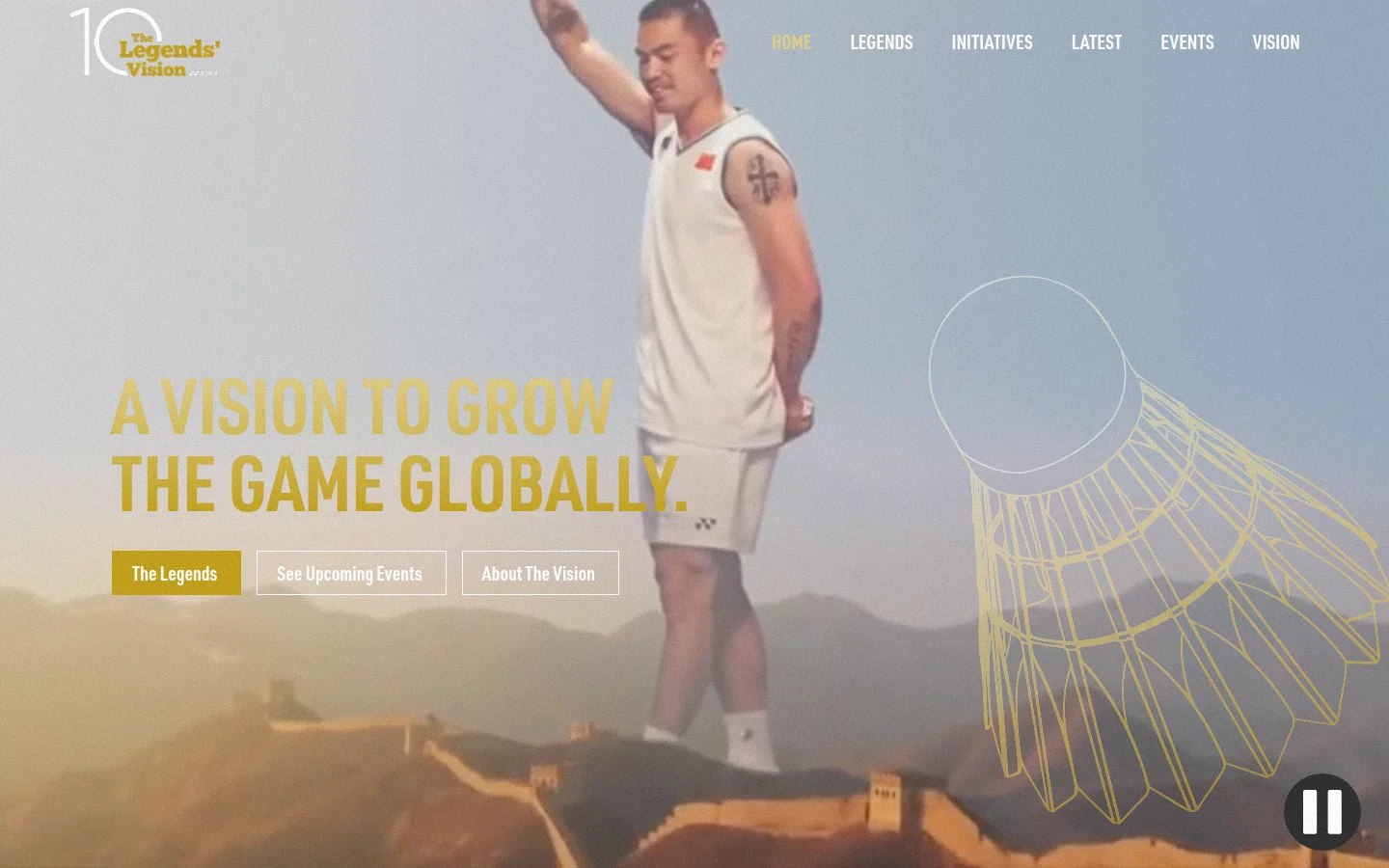 The desktop landing page features a large hero image of a badminton player against a scenic mountain backdrop with a large gold outline of a shuttlecock. The headline 'A VISION TO GROW THE GAME GLOBALLY' is displayed in bold gold text above three rectangular call-to-action buttons: 'The Legends', 'See Upcoming Events', and 'About The Vision'. A navigation menu is visible at the top right, and a pause button sits in the bottom right corner.