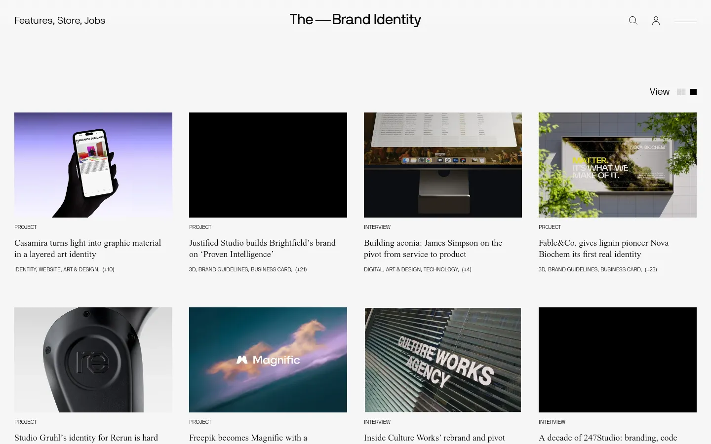 The Features page displays a minimalist grid of design projects and interviews on a white background. Each entry consists of a large rectangular image followed by a category label, a bold headline, and descriptive tags. The desktop layout features a multi-column grid with a clean navigation bar at the top containing a search icon, user profile, and menu.