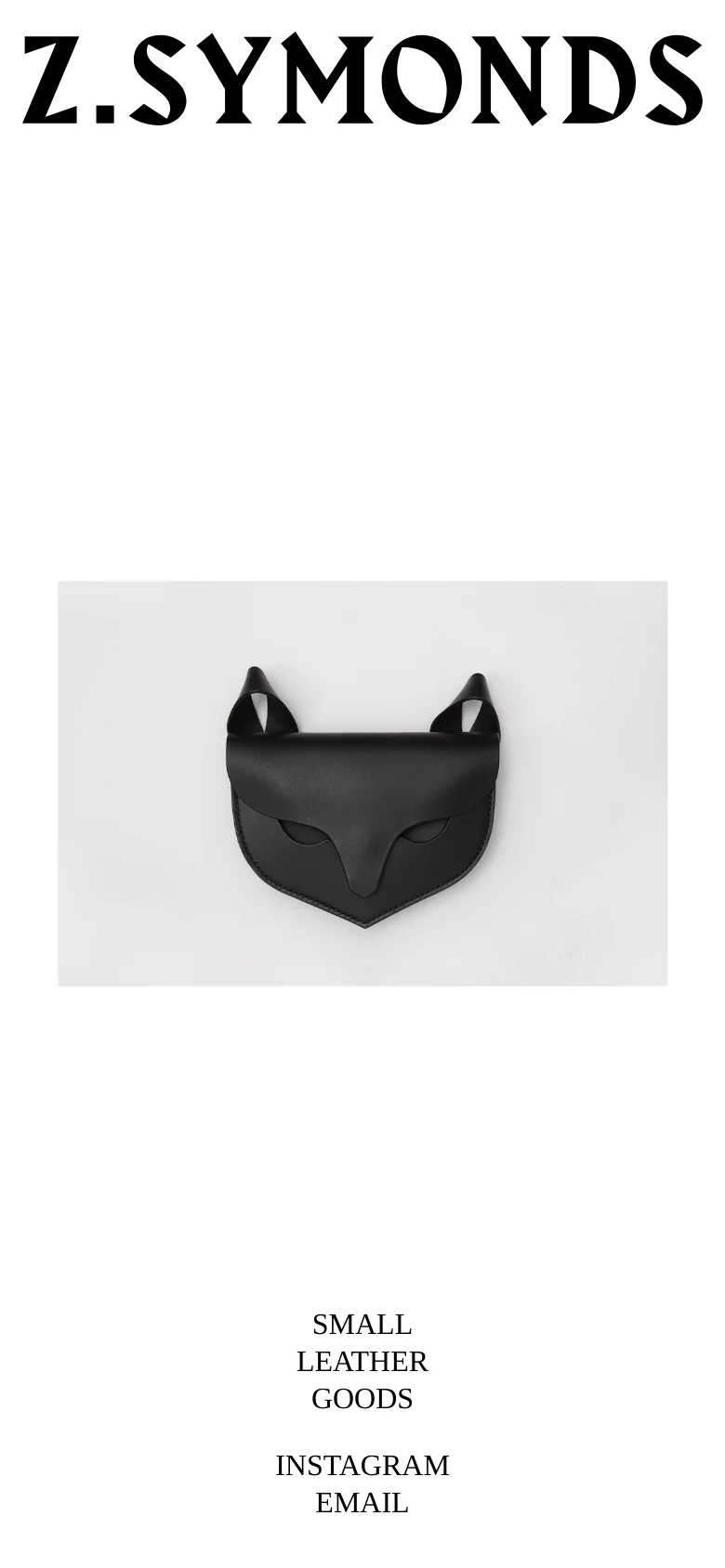 The mobile version maintains the minimalist aesthetic with the 'Z. SYMONDS' logo at the top, followed by a smaller, horizontally oriented hero image of the black leather cat accessory. The text 'SMALL LEATHER GOODS' and contact links are stacked vertically at the bottom of the screen.