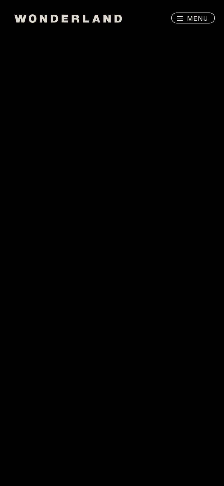 The mobile version presents a simplified, high-contrast view with a large 'WONDERLAND' logo centered at the top. A prominent 'MENU' button with a hamburger icon is positioned in the top right corner against a solid black background, prioritizing easy navigation on a small screen.