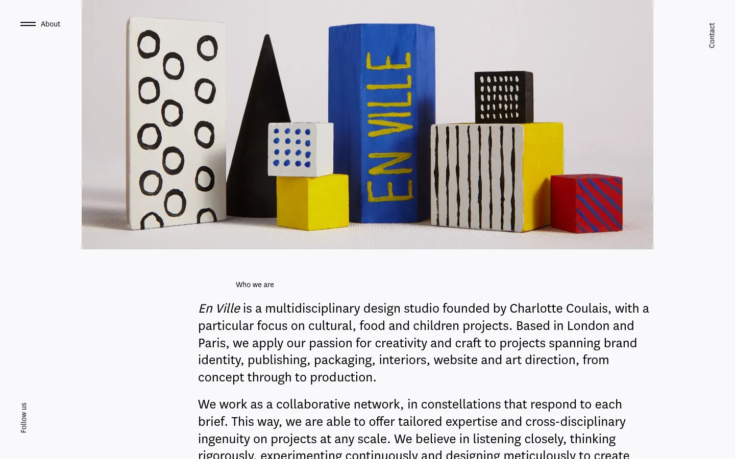 The desktop page features a large hero image of colorful, geometric sculptural blocks against a neutral background. Below, the 'Who we are' section uses clean typography on a white background, with navigation links like 'About' and 'Contact' positioned vertically on the sides. The layout is minimalist with ample white space and a sophisticated, design-focused aesthetic.