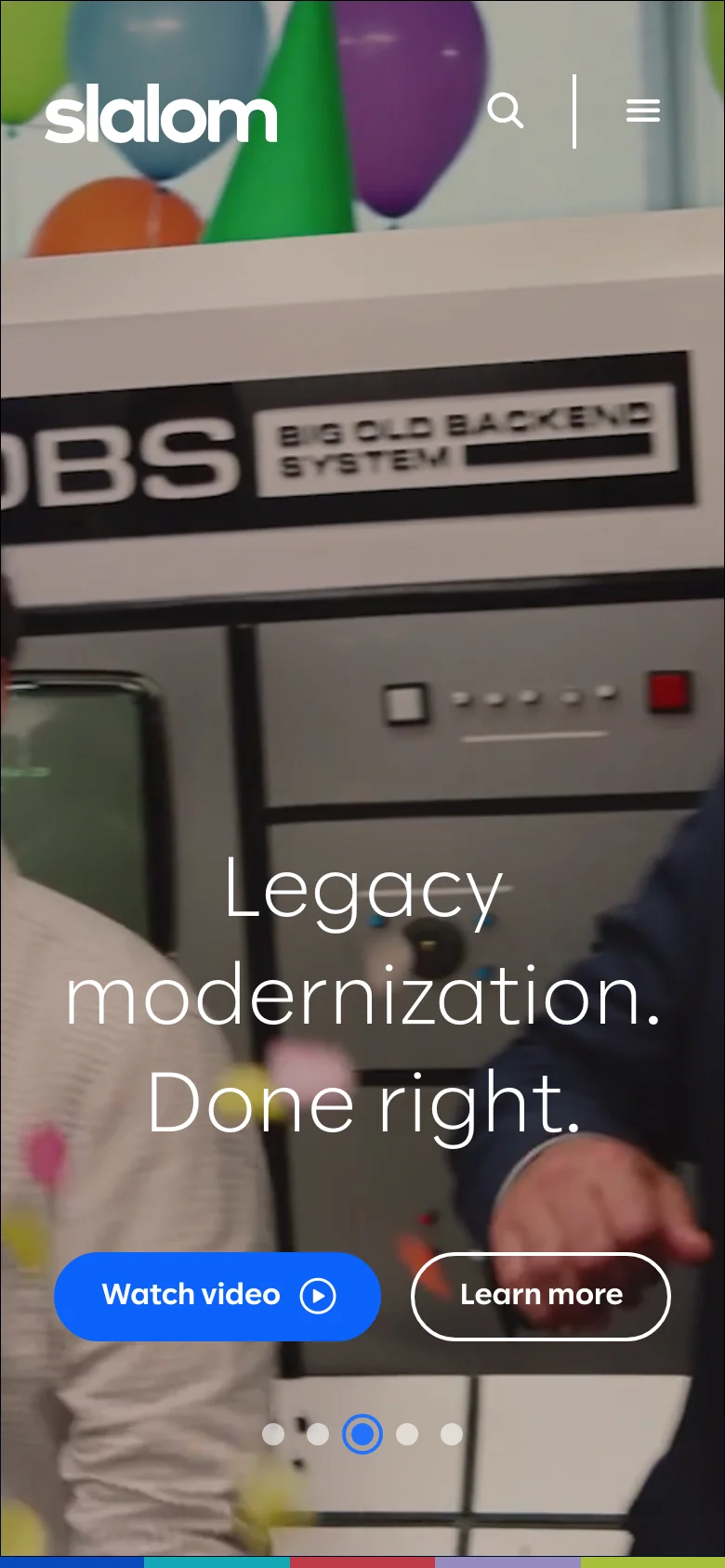 The mobile version displays a simplified layout with the Slalom logo at the top left and a hamburger menu and search icon at the top right. The hero section features a background image of a technical system with the headline 'Legacy modernization. Done right.' and two primary buttons: a blue 'Watch video' button and a transparent 'Learn more' button. A carousel indicator is visible at the bottom of the screen.