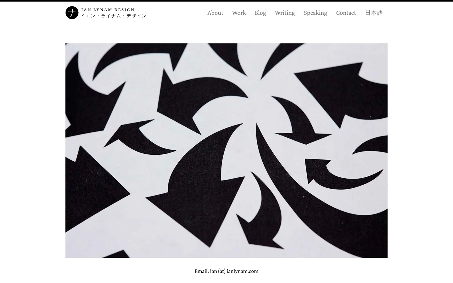 The desktop contact page features a minimalist white background with a large, central black and white abstract graphic of swirling arrow shapes. A top navigation bar includes the Ian Lynam Design logo and links for About, Work, Blog, Writing, Speaking, Contact, and Japanese. Contact information, including email, phone, and Instagram, is displayed in centered serif text below the hero image.