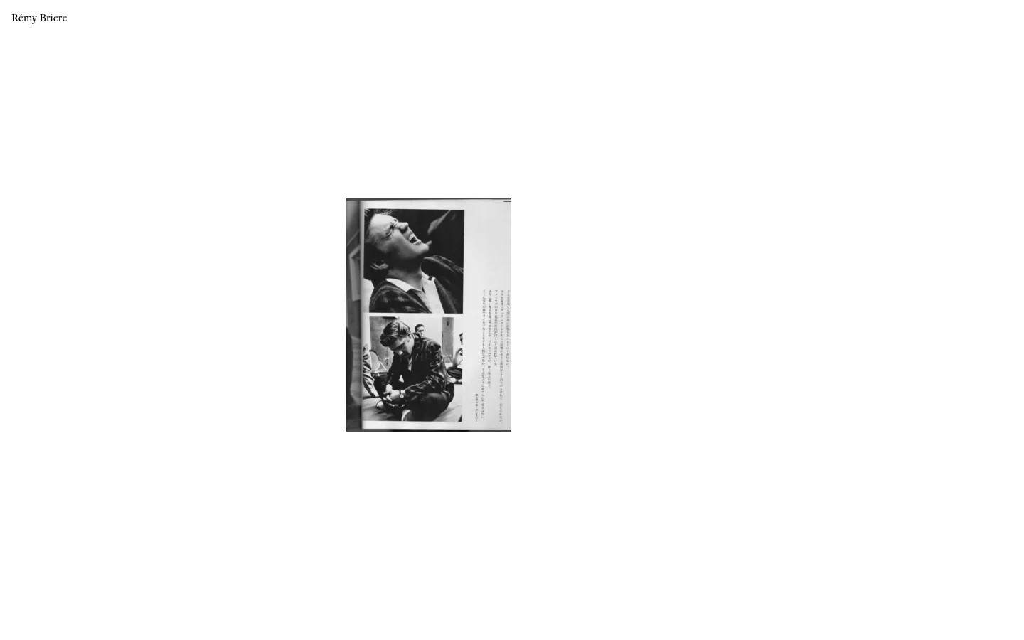 The desktop homepage for Rémy Briere features a minimalist white background with black serif typography. A large, vertical black and white photograph of a man is centered on the page, surrounded by a grid of text links to various creative projects like 'Elvis kisses' and 'Peanuts'.