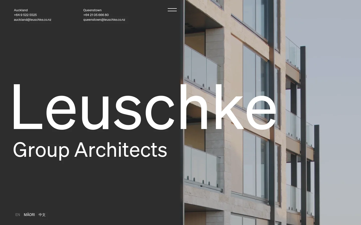 The desktop homepage features a split-screen layout with a dark grey left panel containing the large white text 'Leuschke Group Architects' and contact details for Auckland and Queenstown. The right side shows a high-angle architectural photograph of a modern building with glass balconies against a pale sky.