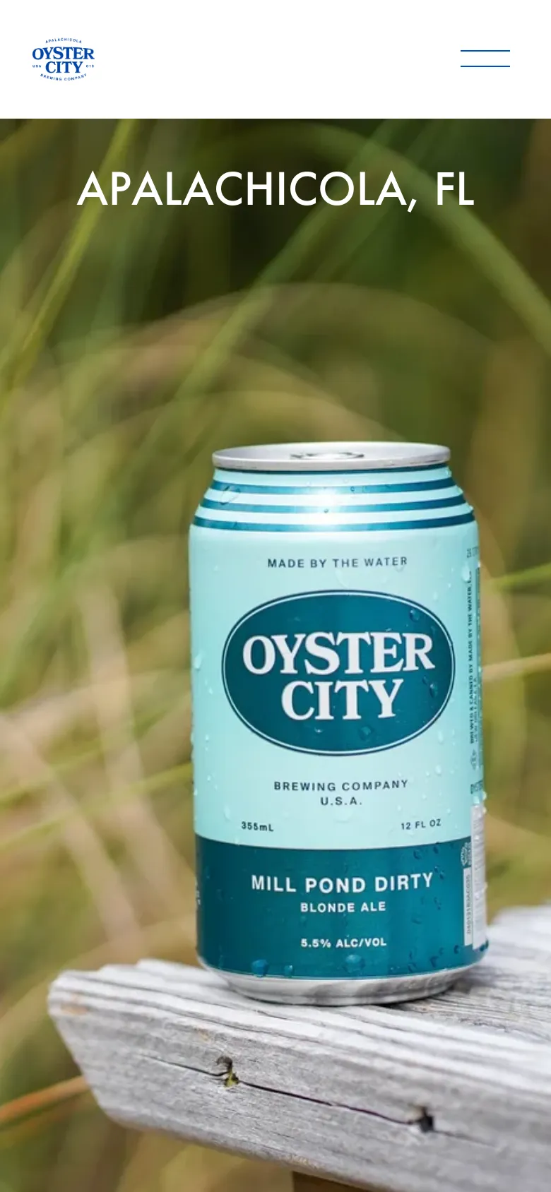 The mobile version displays a simplified header with the Oyster City logo on the left and a hamburger menu icon on the right. The hero section remains prominent, featuring the same large image of the beer can in tall grass with the 'APALACHICOLA, FL' headline centered.