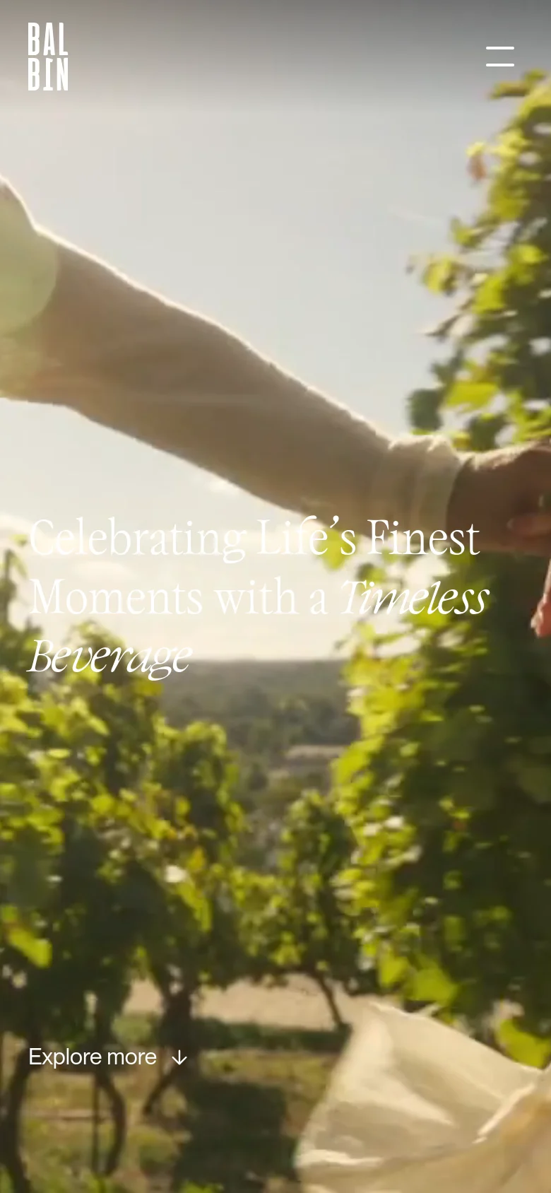 The mobile version presents a vertically oriented hero image showing a sunlit vineyard scene with the same headline centered in white serif text. The navigation is condensed into a hamburger menu icon in the top right, and the 'Explore more' link is positioned at the bottom left.
