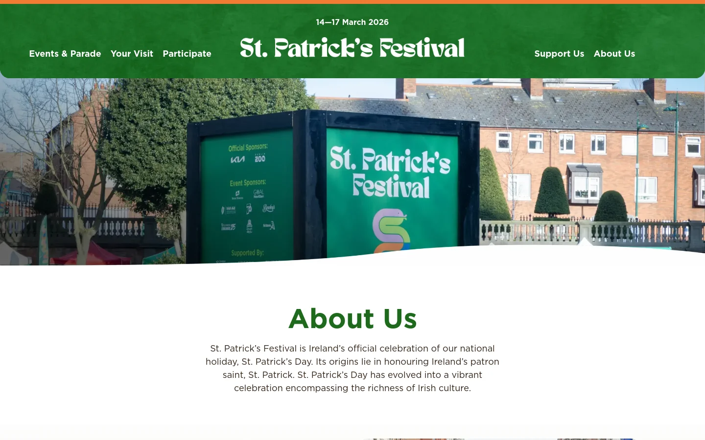 The desktop About Us page features a large green header with the St. Patrick's Festival logo and a navigation menu. Below the header, a wide hero image shows festival signage in front of brick buildings, followed by a large 'About Us' heading and introductory text on a white background. The layout is spacious with centered text and a clean, professional aesthetic.