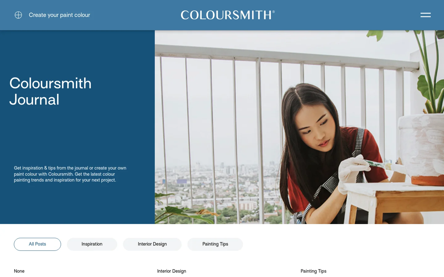 The Coloursmith Journal desktop landing page features a large hero section with a dark blue block containing the title and a description on the left, and a lifestyle photo of a woman painting on the right. Below the hero, a navigation bar offers filter buttons for All Posts, Inspiration, Interior Design, and Painting Tips against a white background.