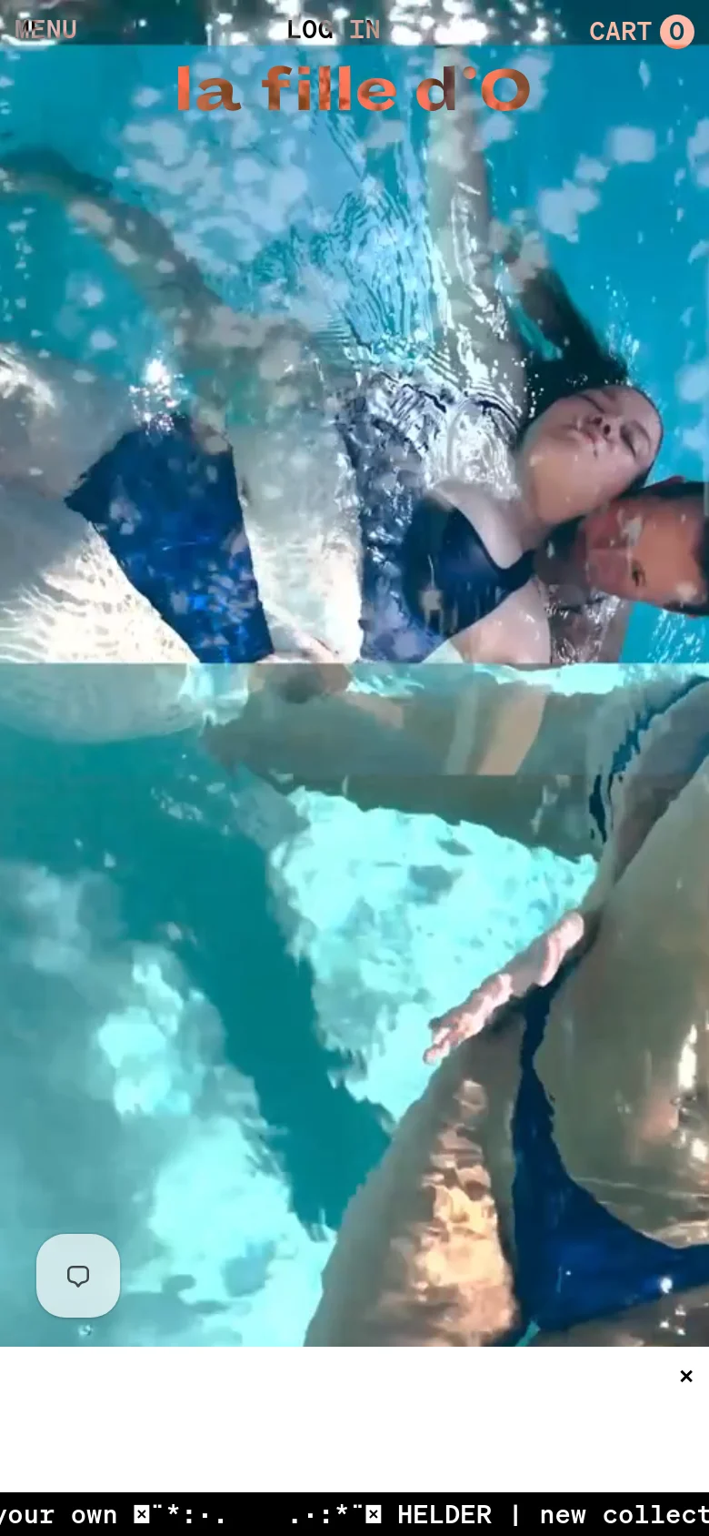 The mobile version presents a vertically oriented view of the hero imagery showing a person in blue swimwear underwater. The brand name 'la fille d'O' is prominently displayed in orange in the upper center, and the navigation is condensed into a 'MENU' button at the top left. A floating chat icon is visible in the bottom left corner over the blue water background.