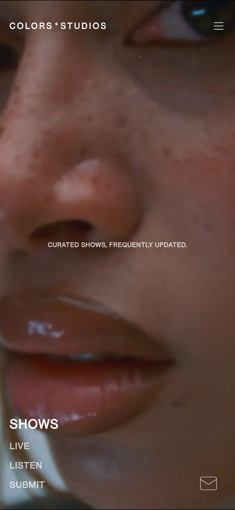 The mobile version maintains the close-up artistic background imagery but shifts the layout to a vertical orientation. The brand name and menu icon remain at the top, while the navigation links (SHOWS, LIVE, LISTEN, SUBMIT) are stacked vertically on the left side of the screen. A large 'SHOWS' headline is prominent in the lower-left area.