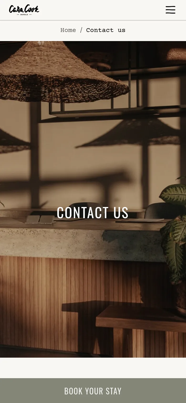 The mobile version shows the same warm, sunlit hotel bar hero image with the 'CONTACT US' headline centered. The layout is vertically stacked, and the bottom booking bar is replaced by a full-width, prominent 'BOOK YOUR STAY' call-to-action button in a muted sage green color.