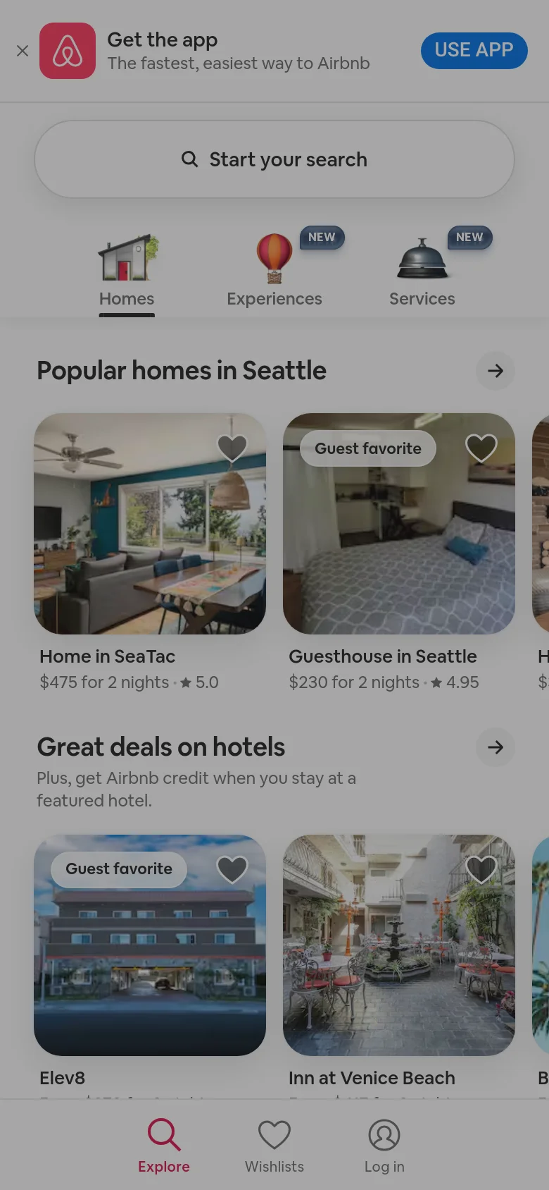 The mobile version presents a simplified, vertically stacked interface optimized for touch. A large 'Start your search' button dominates the top, followed by icon-based navigation for Homes, Experiences, and Services. Property listings like 'Home in SeaTac' and 'Guesthouse in Seattle' are shown as large, single-column cards with high-quality imagery, and a bottom navigation bar provides quick access to Explore, Wishlists, and Log in.
