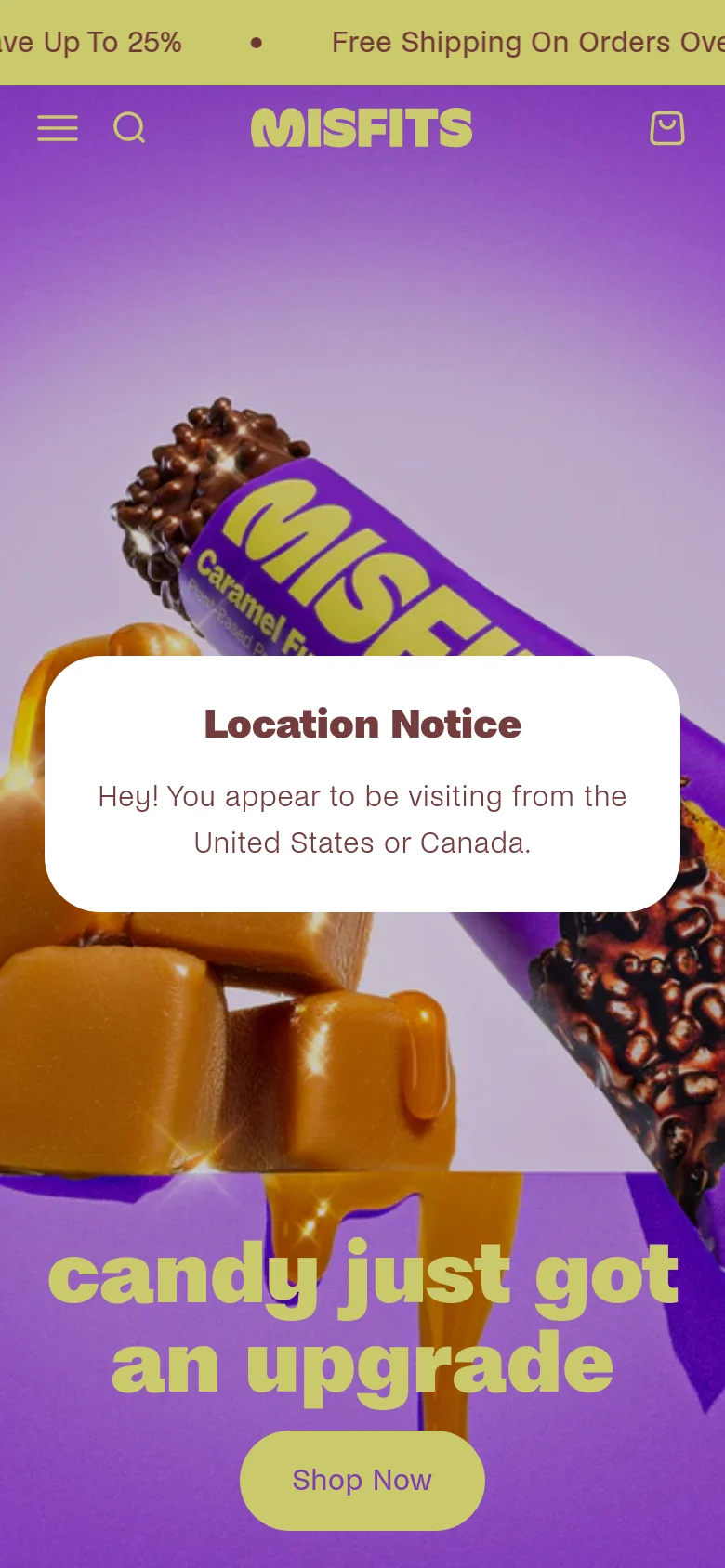 Mobile version of the Misfits homepage with a vertical layout centered on the hero image of chocolate bars and caramel. The headline 'candy just got an upgrade' and a lime green 'Shop Now' button are positioned below a large 'Location Notice' pop-up. The header is simplified with a hamburger menu, search icon, brand logo, and shopping bag icon.