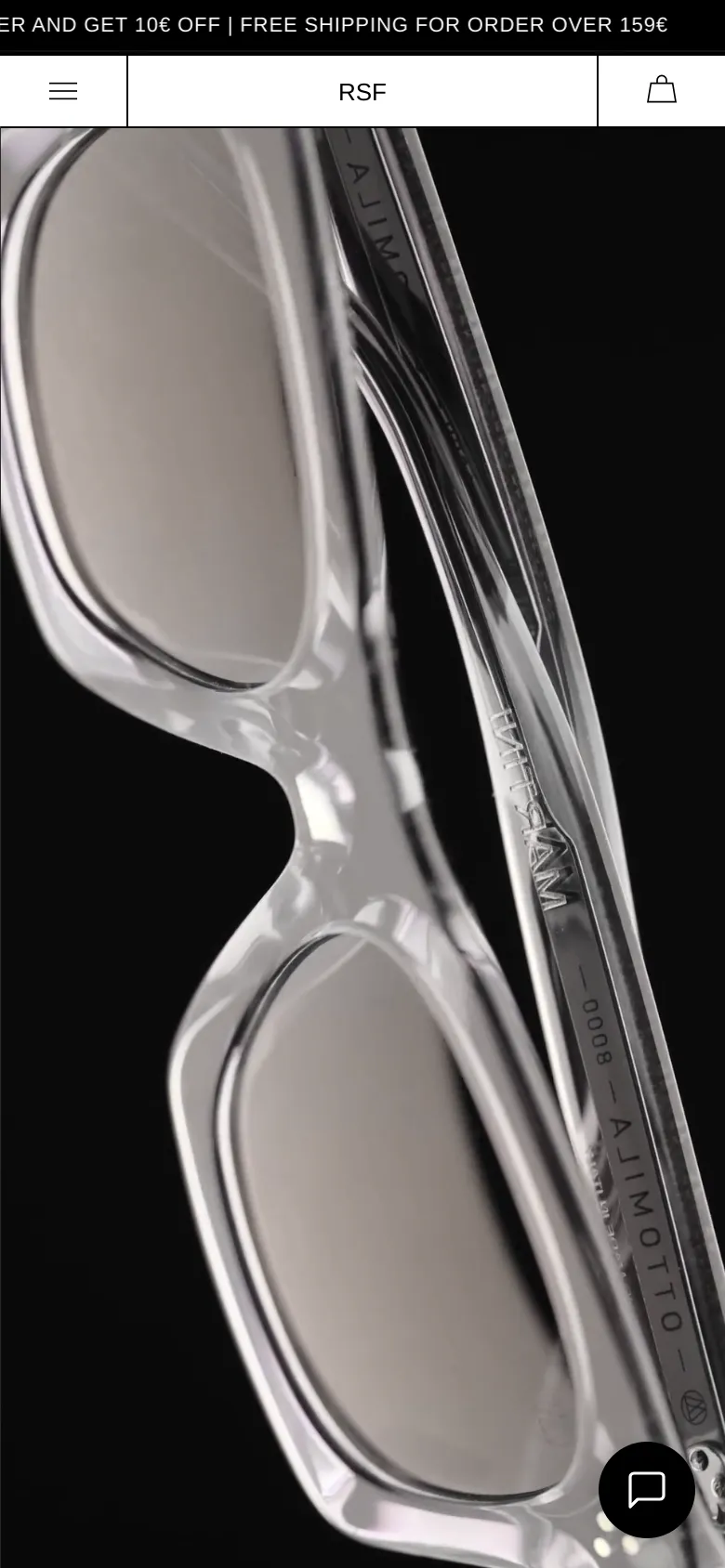 Mobile version of the 8000 eyewear page, centered on a vertical, close-up hero shot of clear sunglasses. The navigation is simplified to a hamburger menu, the brand name 'RSF', and a shopping bag icon at the top. A promotional banner for free shipping is visible at the very top, and a chat bubble icon sits in the bottom right corner.