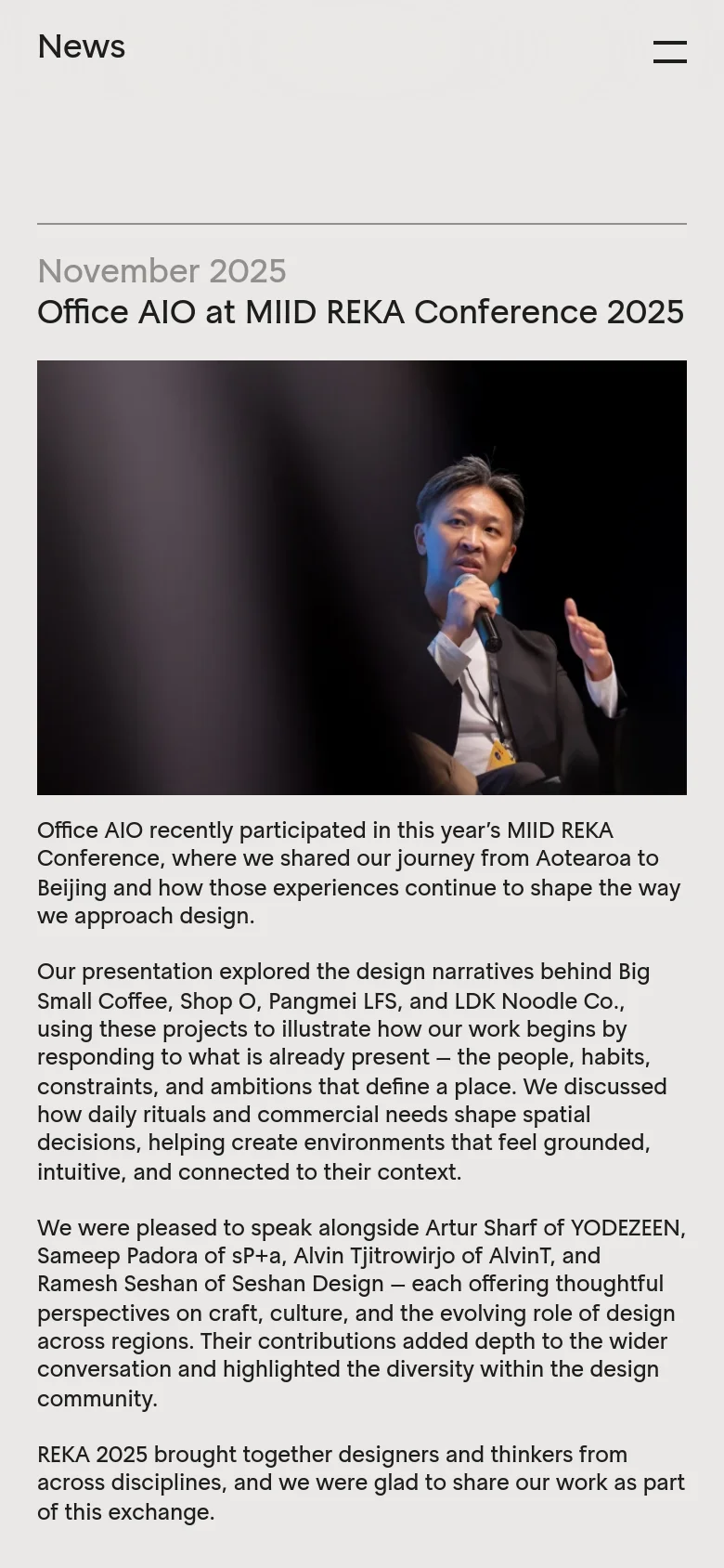 The mobile version simplifies the layout into a single vertical column. The navigation menu is replaced by a hamburger icon at the top right, and the news content, including the 'Office AIO at MIID REKA Conference 2025' headline, image, and text, spans the full width of the screen.