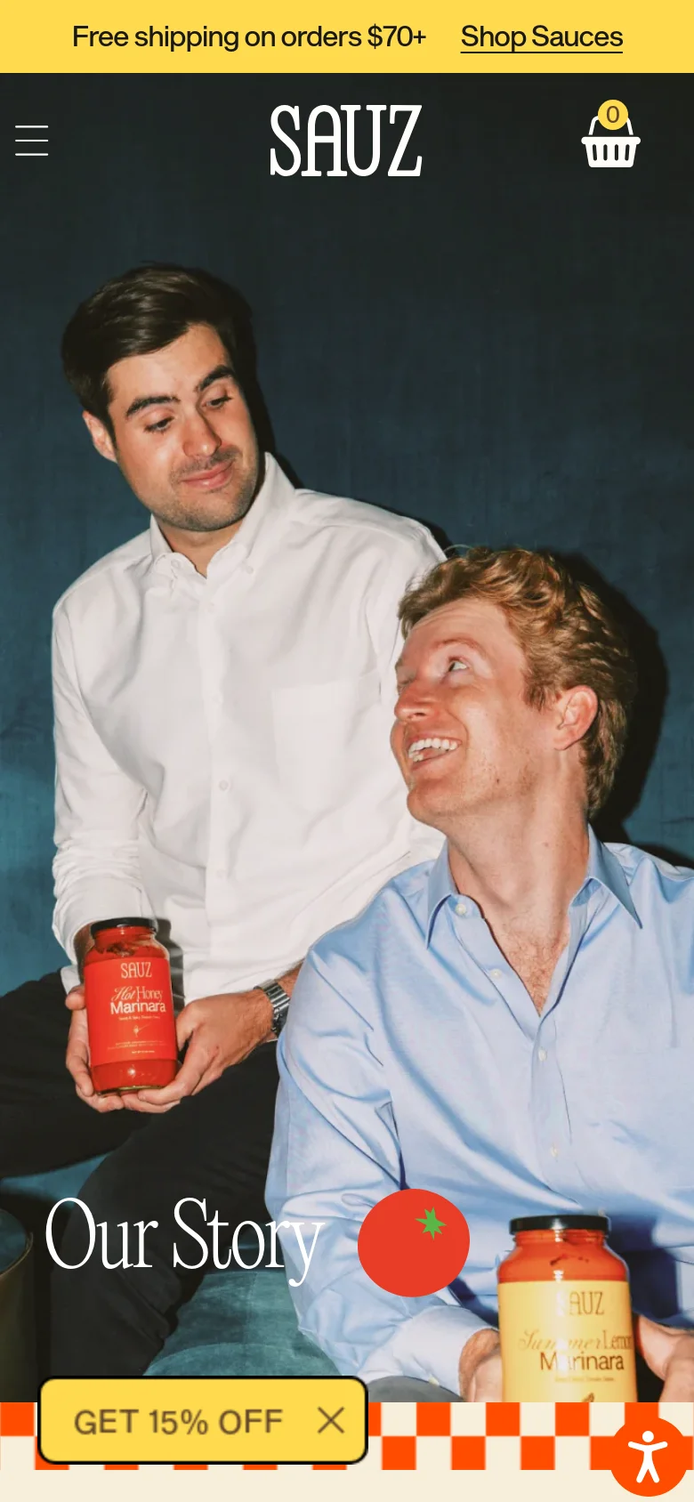 The mobile version presents a vertically oriented hero image of the two co-founders, with the 'Our Story' headline and tomato graphic positioned lower on the screen. The top navigation is condensed into a hamburger menu icon, and the 'GET 15% OFF' call-to-action button spans a larger portion of the bottom width. The overall color palette remains dark teal, bright yellow, and orange checkered patterns.