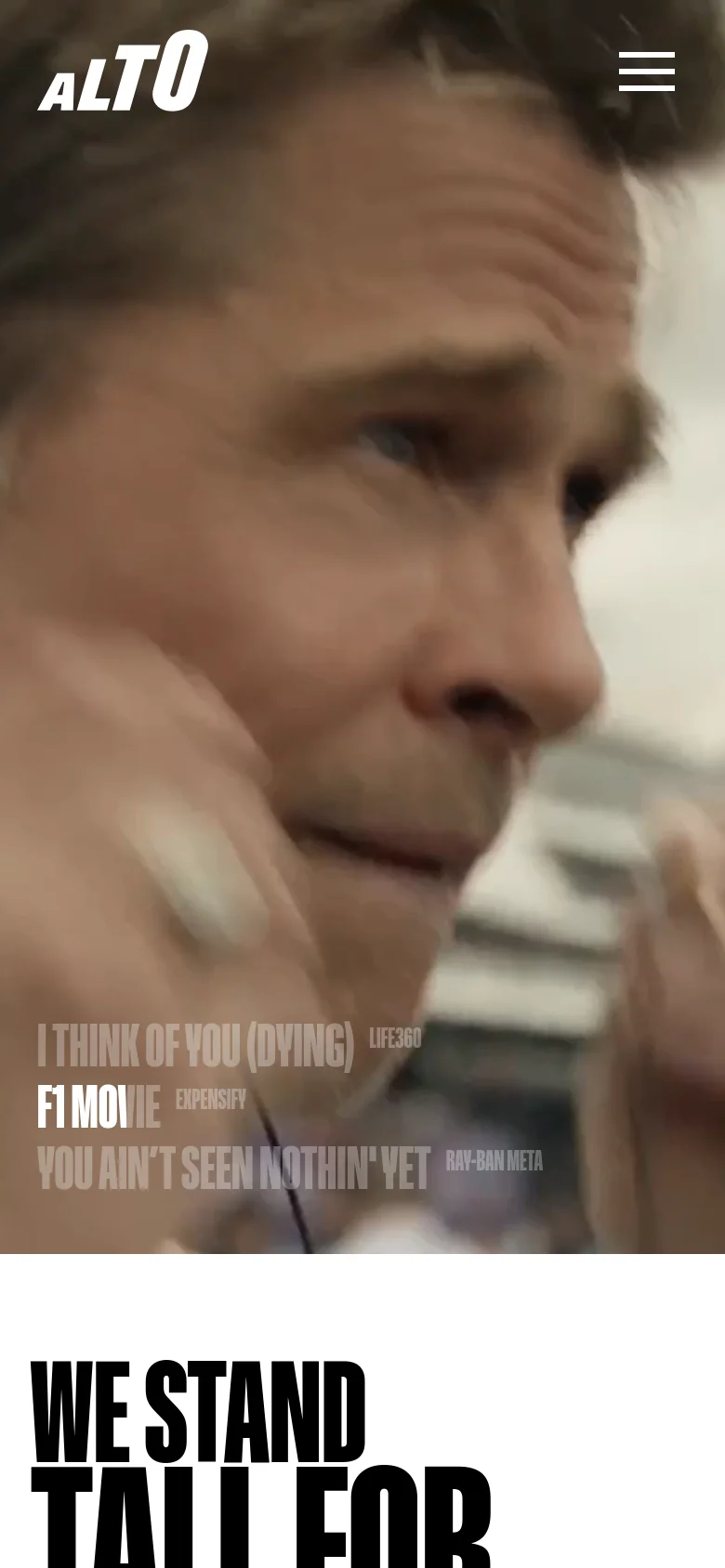 The mobile version presents a vertically stacked layout, starting with a full-width hero image of a person's face overlaid with large, bold white text. Below the hero section, the content transitions to a clean white background with large, heavy black typography for headings. The navigation is condensed into a hamburger menu icon at the top right.