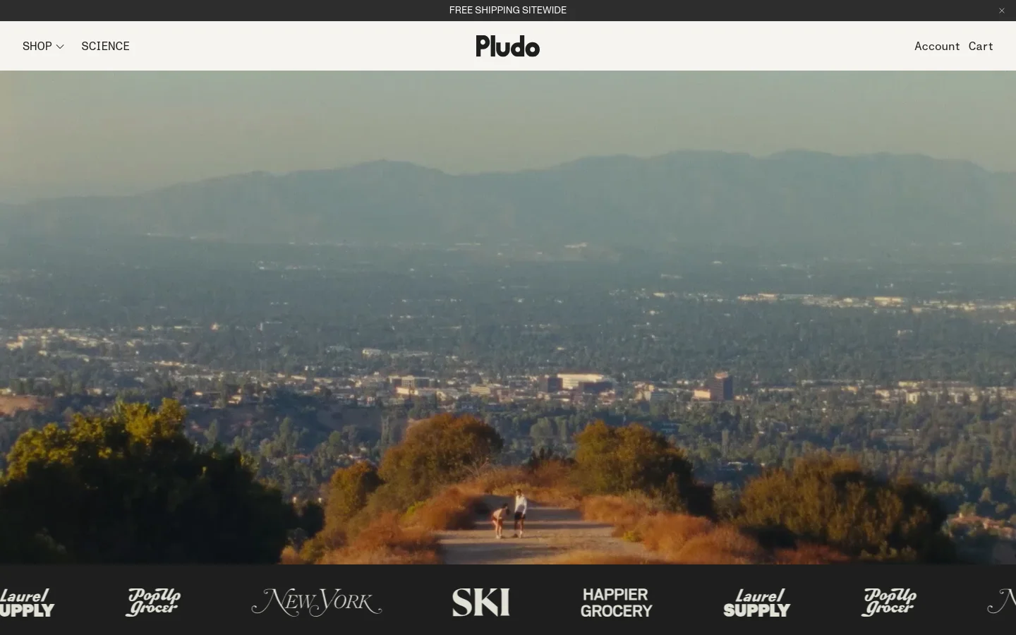 The desktop homepage features a wide hero image of a scenic mountain landscape with people jogging on a trail. Below the hero section, a headline reads 'The best-tasting electrolytes' next to a 'Shop All Flavors' button, followed by a horizontal row of press logos including New York Magazine and Ski Magazine.