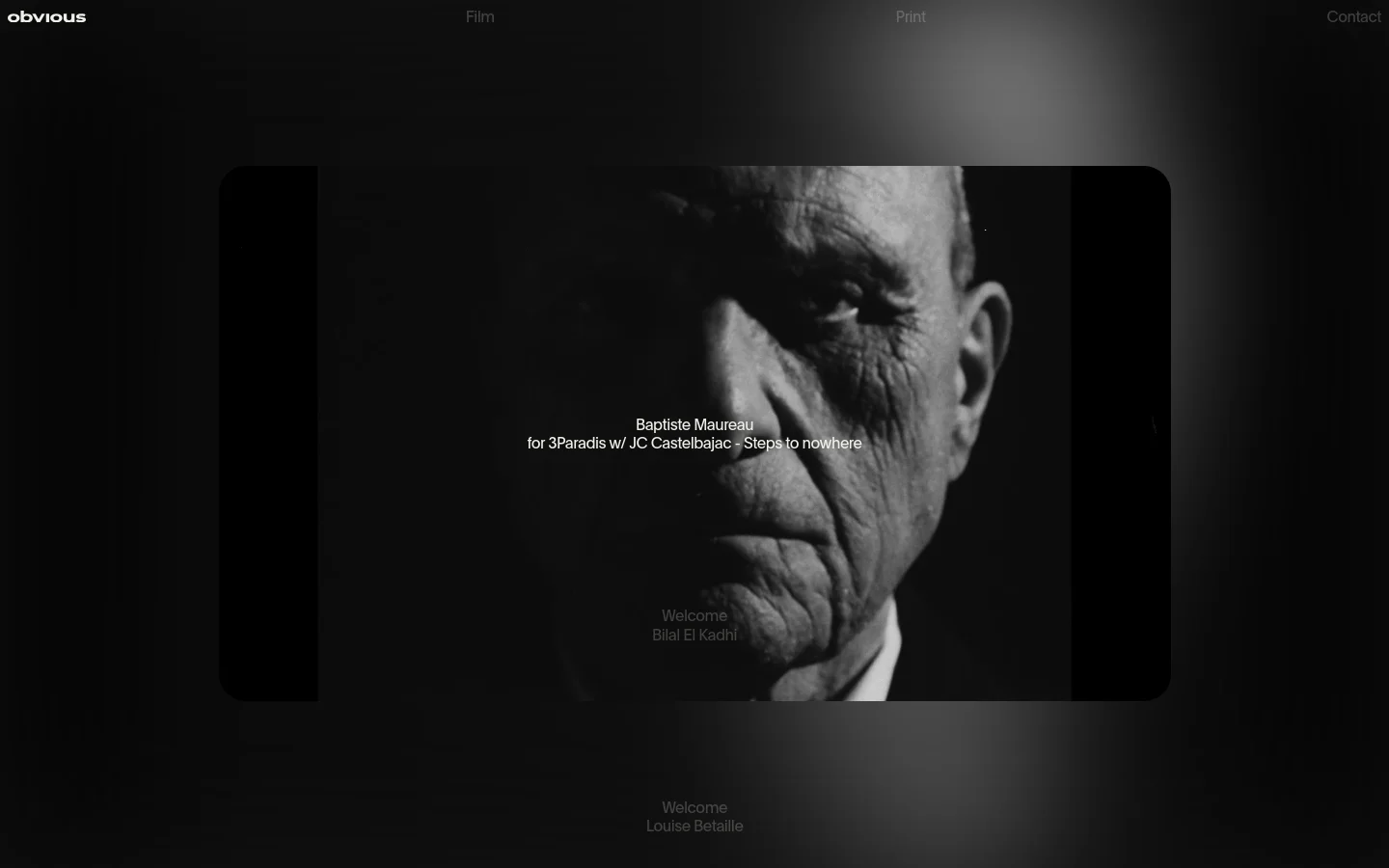 The desktop homepage features a minimalist dark design with a large, cinematic black and white close-up portrait as the hero image. Navigation links for Film, Print, and Contact are positioned at the top, and a news feed with text links is overlaid on the central imagery.