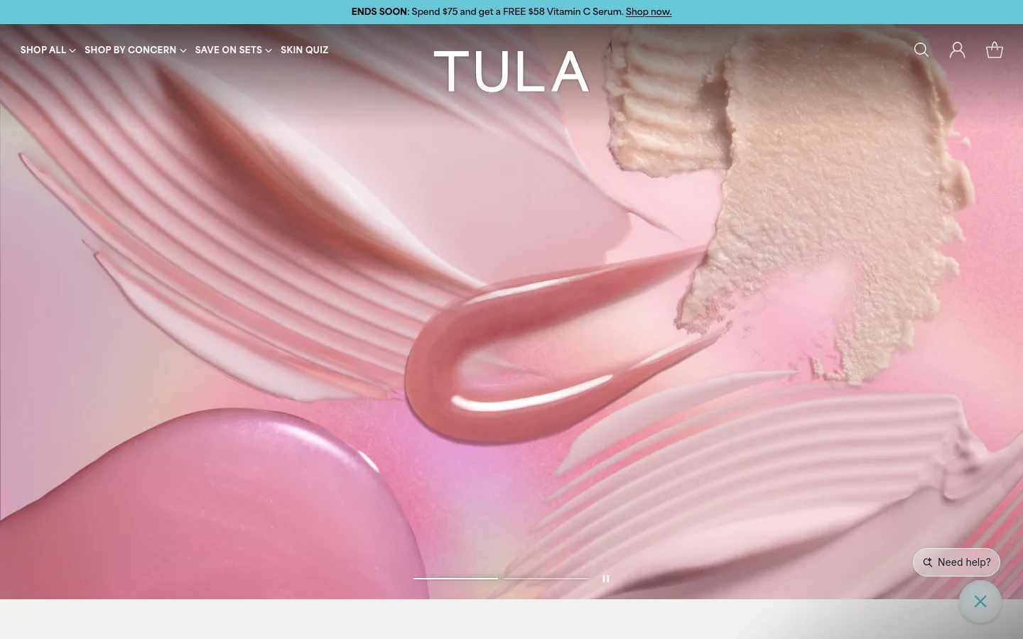 The TULA desktop homepage features a large hero image of pink and cream skincare textures with the brand name centered. A top announcement bar offers a free serum with purchase, and a navigation menu includes links for Shop All, Shop by Concern, Save on Sets, and a Skin Quiz. The layout is clean with a minimalist white and pink color palette.