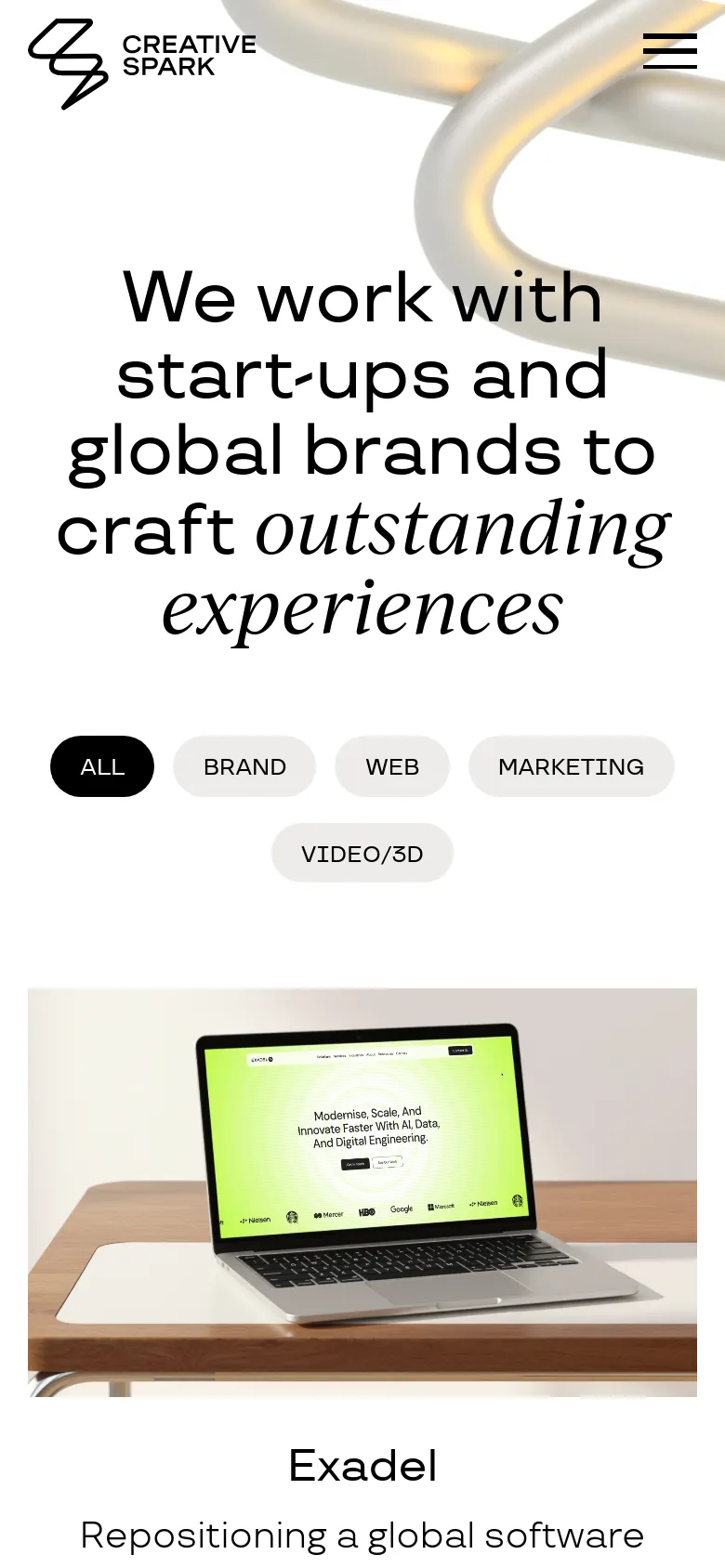 The mobile version presents a vertically stacked layout with the Creative Spark logo and a hamburger menu icon at the top. The large headline is centered over the abstract 3D silver imagery, followed by the filter buttons arranged in two rows. Below the hero section, a project card for 'Exadel' is visible, featuring a large image of a laptop on a wooden desk.