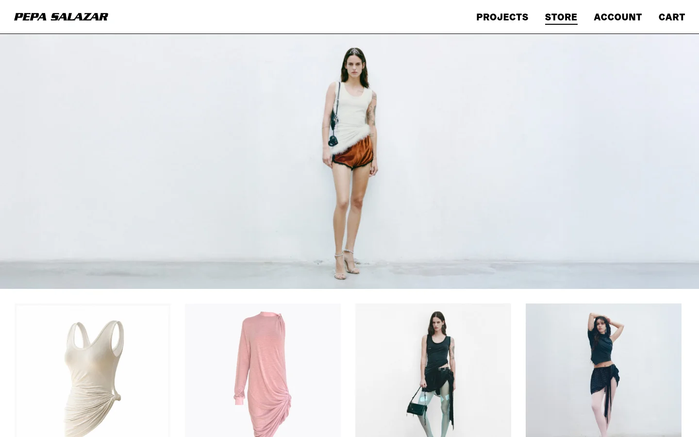 The desktop store page features a minimalist white layout with a large hero image of a model in a white tank top and orange shorts. Below, a grid displays product images including a white tank top and a pink dress, each accompanied by a title, price, and 'Add to Cart' button. The navigation menu is positioned at the top right with links for Projects, Store, Account, and Cart.