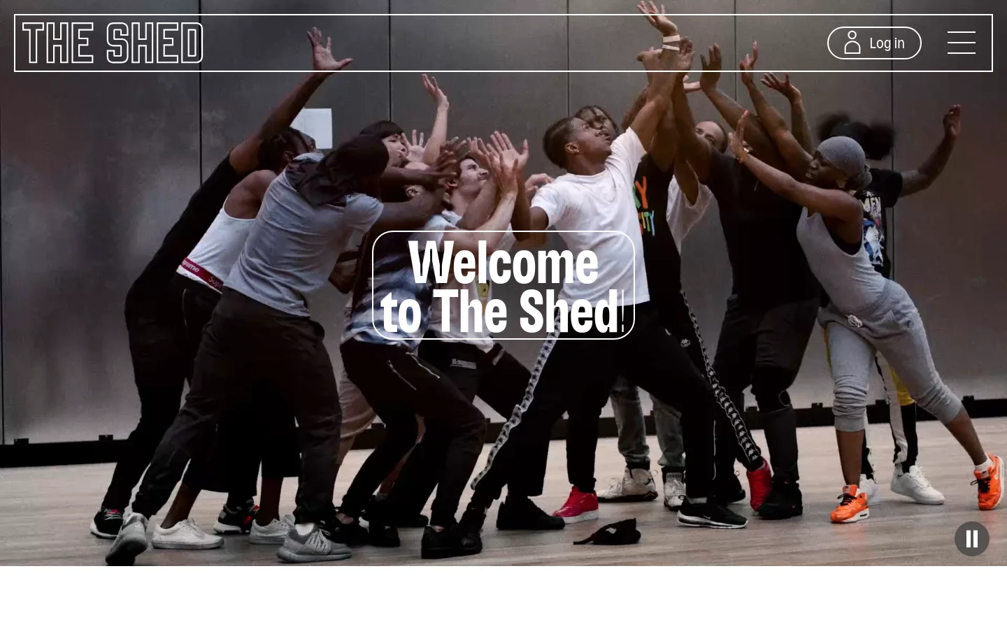 The desktop homepage features a large, full-width hero video of people dancing, overlaid with the white text 'Welcome to The Shed'. A minimalist navigation bar at the top includes 'THE SHED' logo, a 'Log in' button, and a hamburger menu icon. The layout is clean with a dark, cinematic aesthetic.