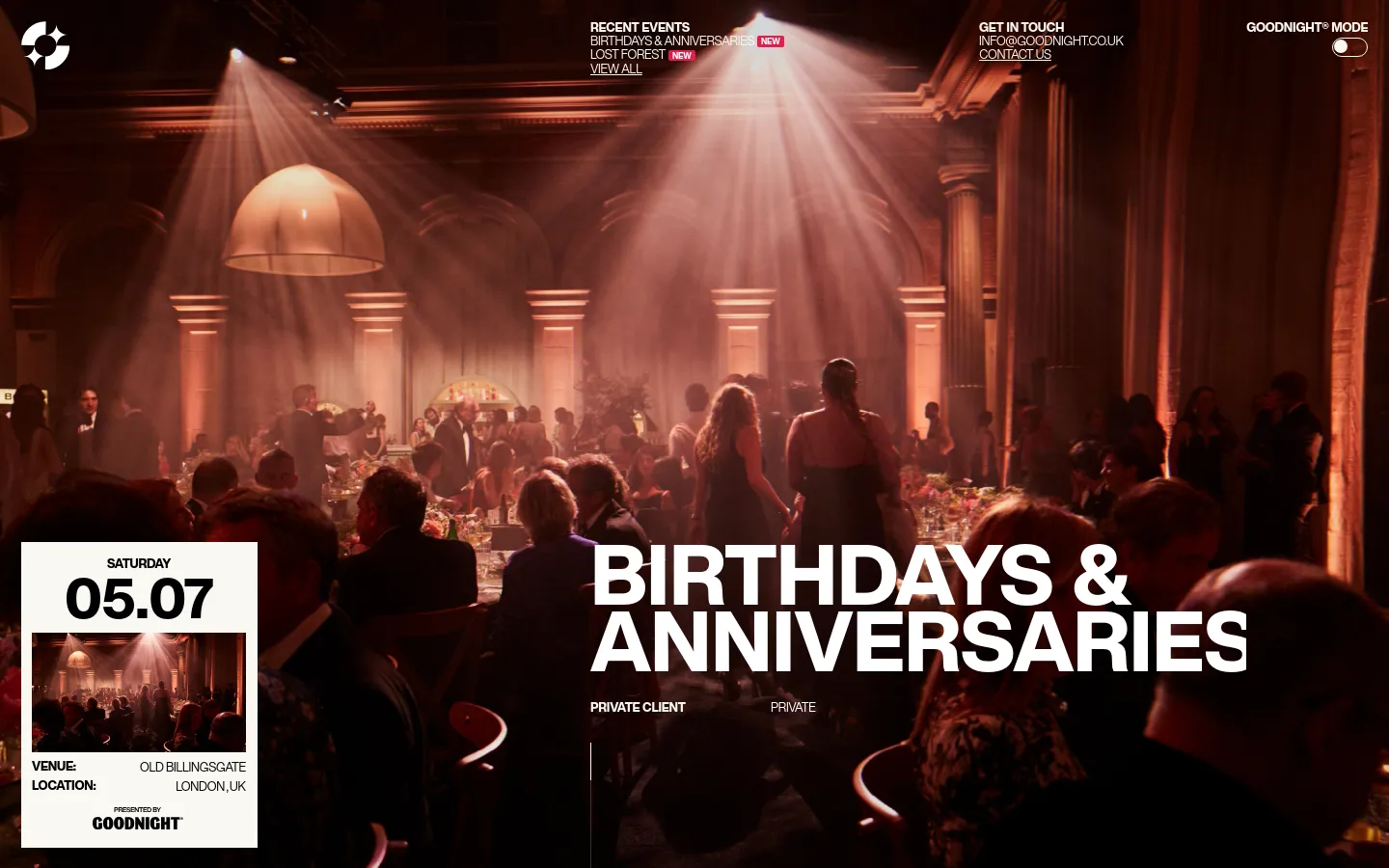 Goodnight event page for a Birthdays & Anniversaries celebration at Old Billingsgate. A full-bleed hero image shows a moody, dimly lit banquet hall with warm spotlighting and guests, overlaid with large white sans-serif typography and a minimalist info card. The design uses a sophisticated dark, cinematic aesthetic with high-contrast text.