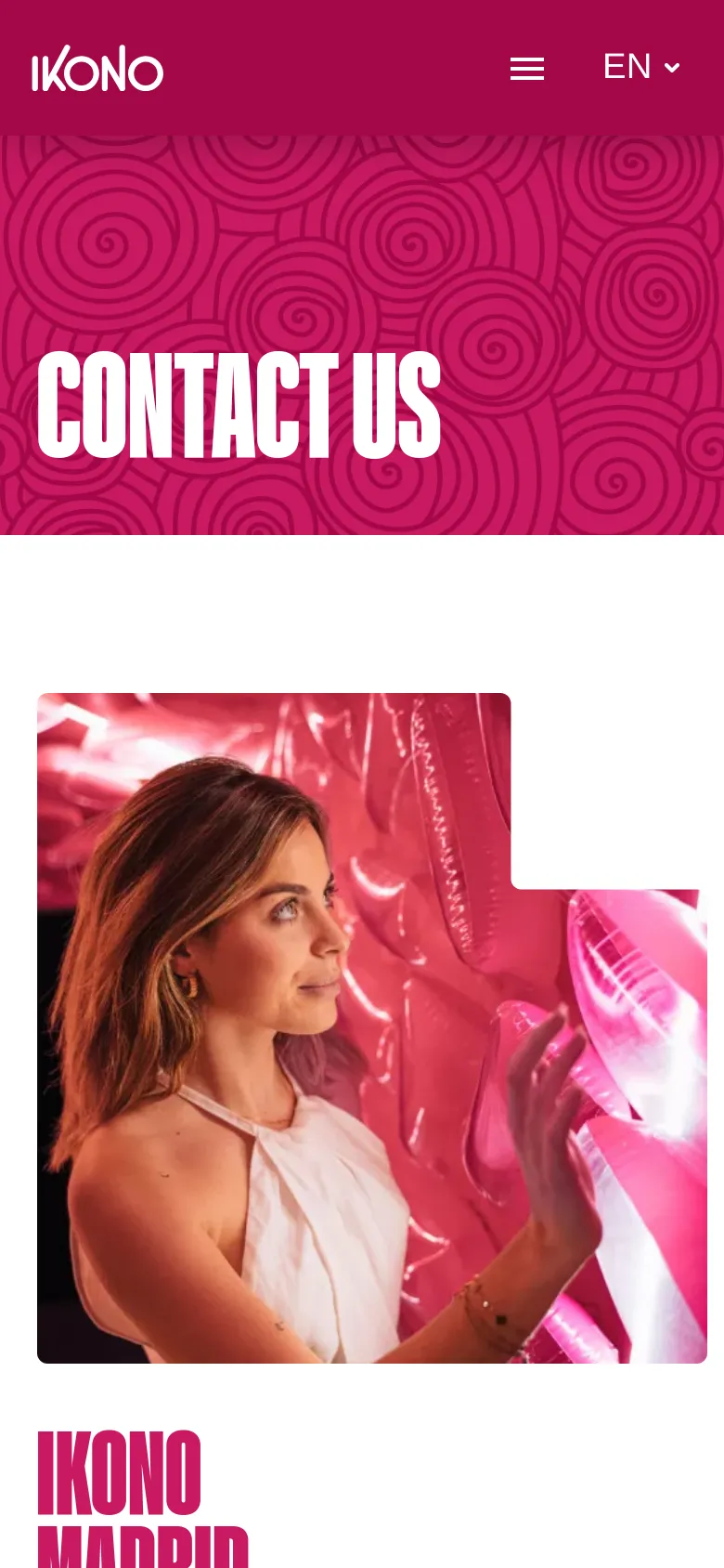 The mobile version displays a simplified vertical layout with the pink swirling hero banner at the top. The contact information and lifestyle imagery are stacked vertically to fit the narrow screen, and the top navigation is condensed into a hamburger menu icon next to the language selector.