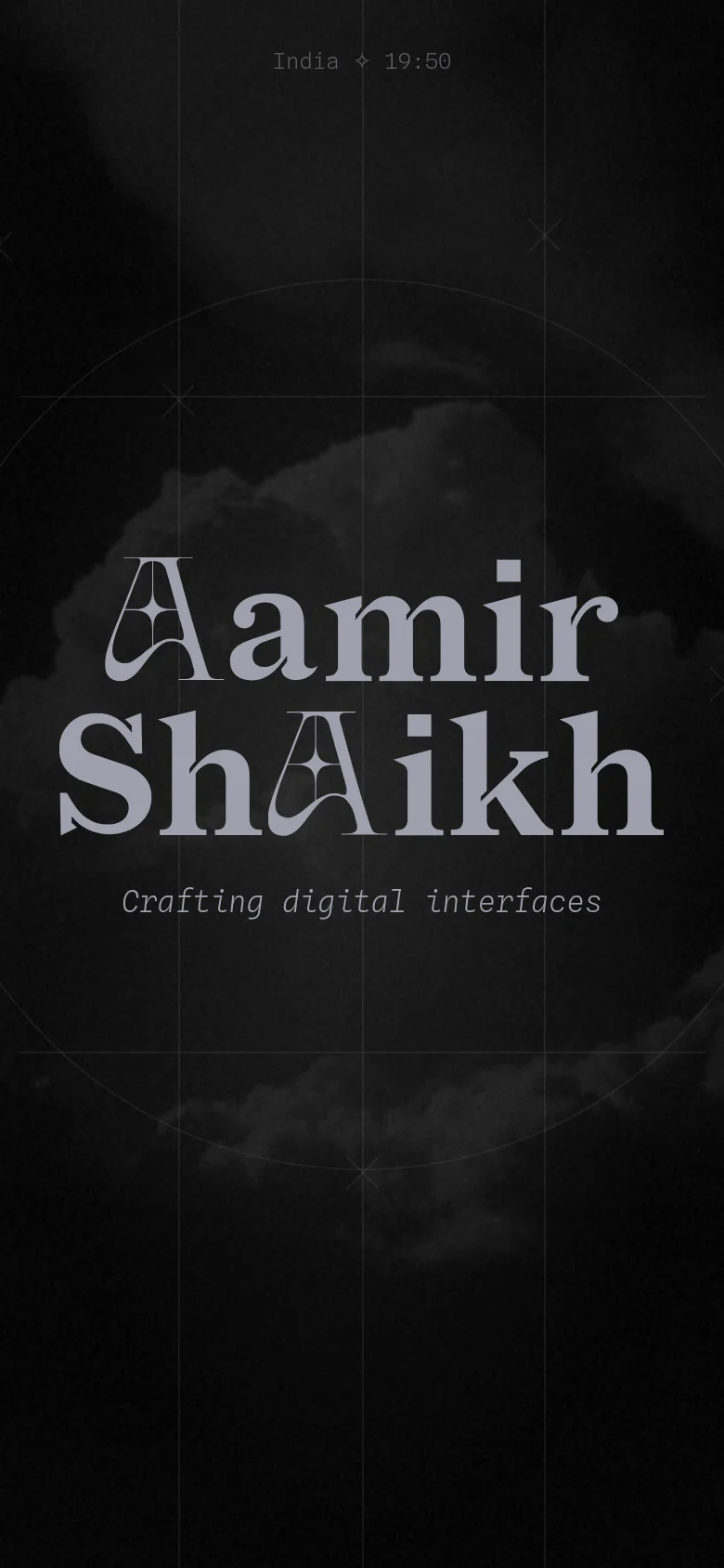 The mobile version maintains the dark, atmospheric cloud background and large stylized name 'Aamir Shaikkh' centered on the screen. The layout is vertically compressed, removing the secondary role descriptions and focusing primarily on the name and the tagline 'Crafting digital interfaces' in a monospaced font.