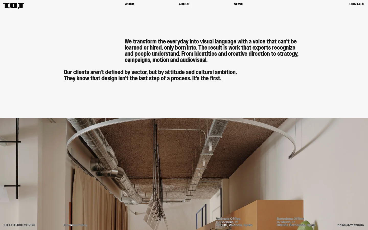 The About page features a minimalist design with black text on a white background. A large hero section contains mission statements in bold typography, followed by a wide, cinematic photograph of a modern, industrial-style studio interior with exposed pipes and warm lighting. A simple navigation menu sits at the top, and contact information is located in the footer.