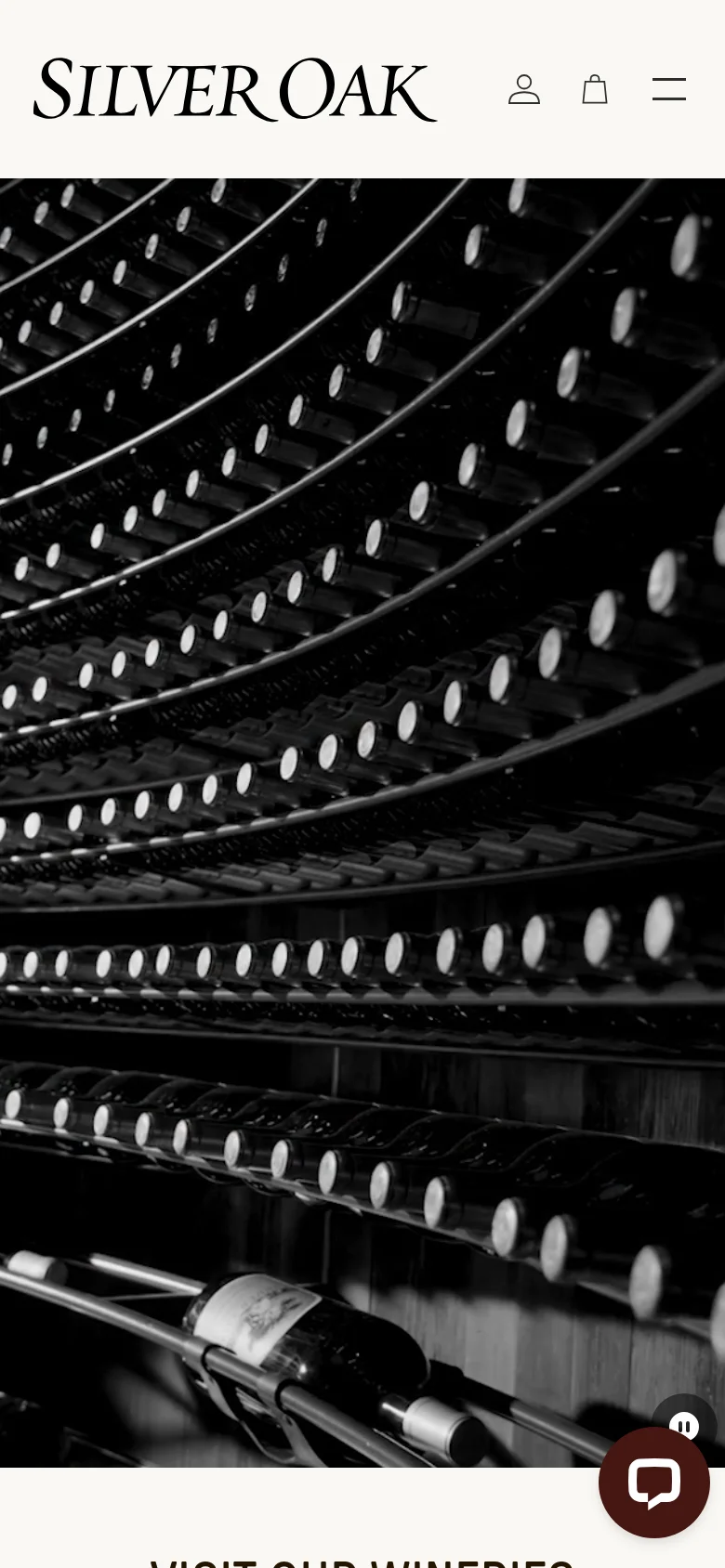 The mobile version uses a vertically stacked layout, beginning with a black-and-white close-up image of wine bottles in a cellar as the hero element. The navigation is condensed into a hamburger menu, and the winery experience sections are arranged in a single column for easier scrolling.