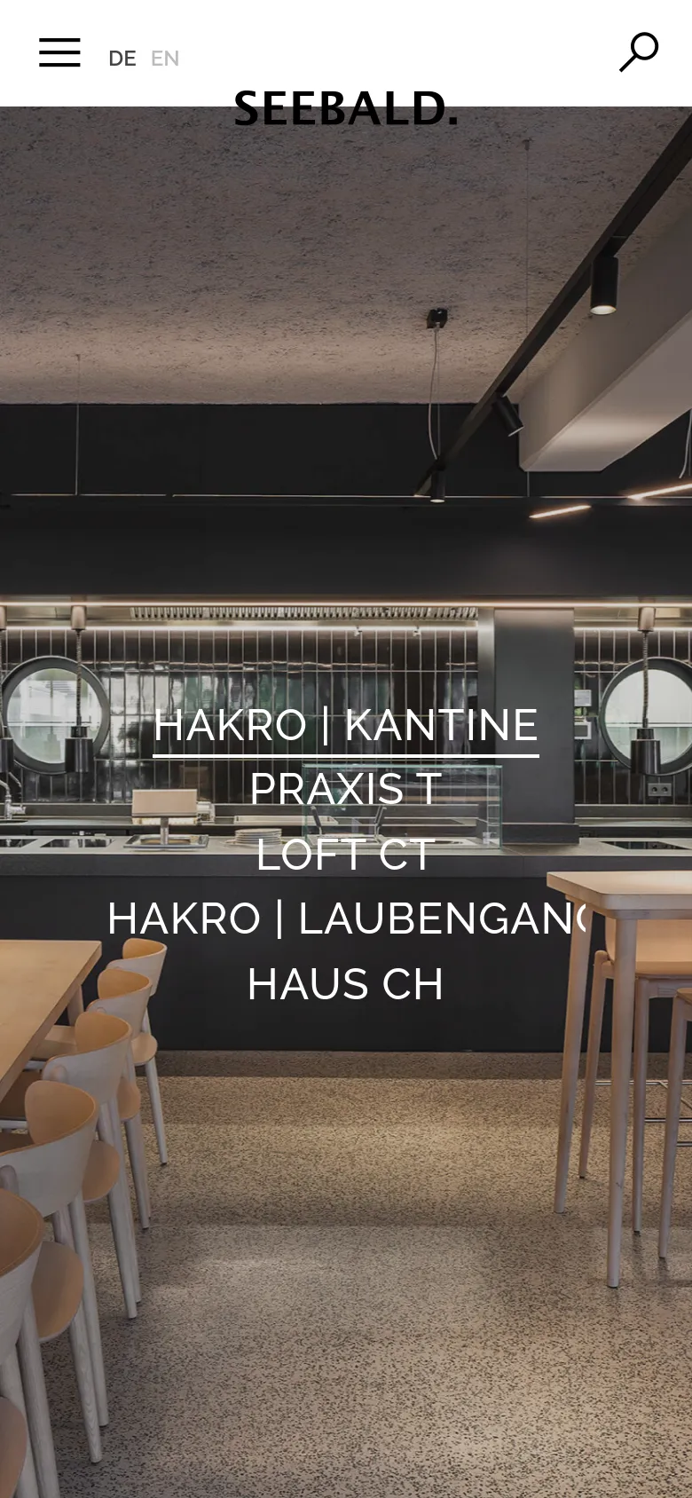 The mobile version maintains the minimalist aesthetic with a white header, but the menu icon and search icon are more prominent. The hero image of the modern canteen remains the background, with the project text links stacked vertically in a centered, large white font to fit the narrower screen.