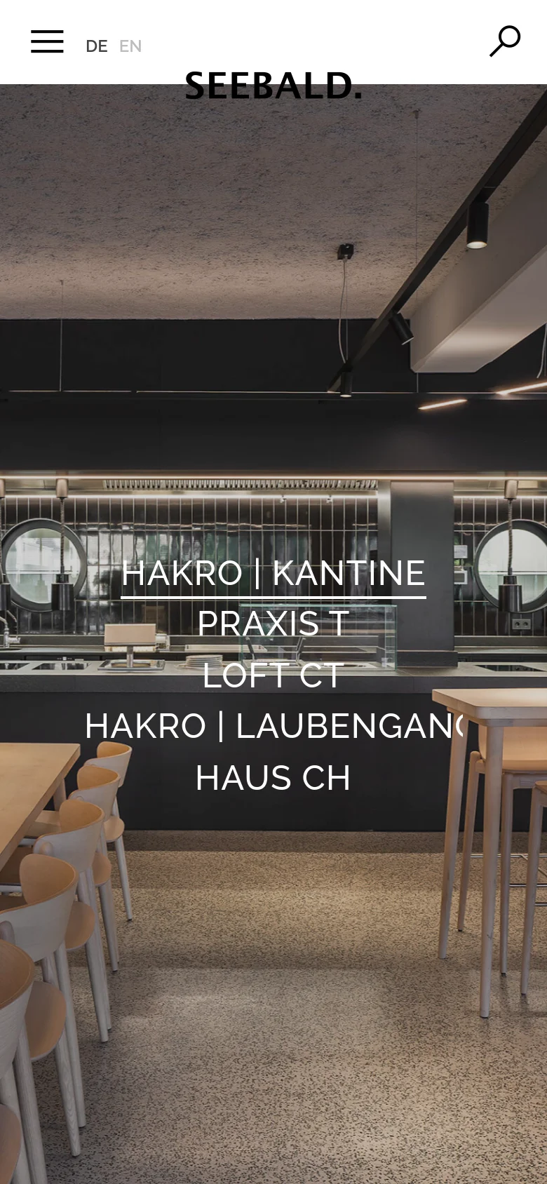 The mobile version maintains the minimalist aesthetic with a white header, but the menu icon and search icon are more prominent. The hero image of the modern canteen remains the background, with the project text links stacked vertically in a centered, large white font to fit the narrower screen.
