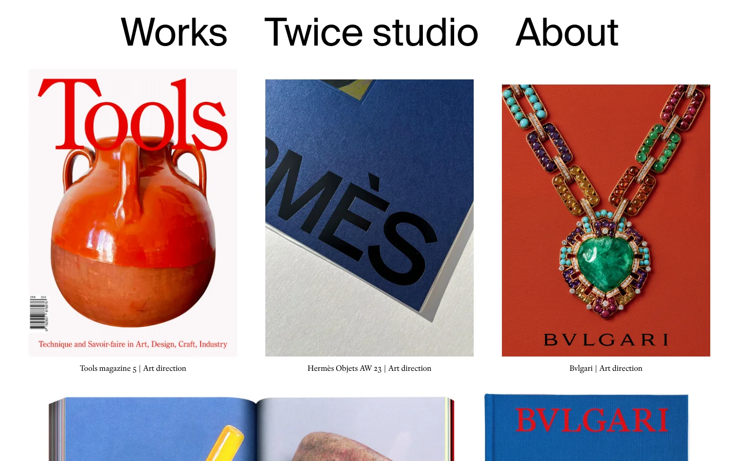 The desktop homepage for Twice studio features a minimalist white header with 'Works', 'Twice studio', and 'About' links. Below, a grid of large, high-quality portfolio images showcases various art direction projects like Tools magazine and Bvlgari, each accompanied by a text caption. The layout is clean and spacious, emphasizing the visual content.